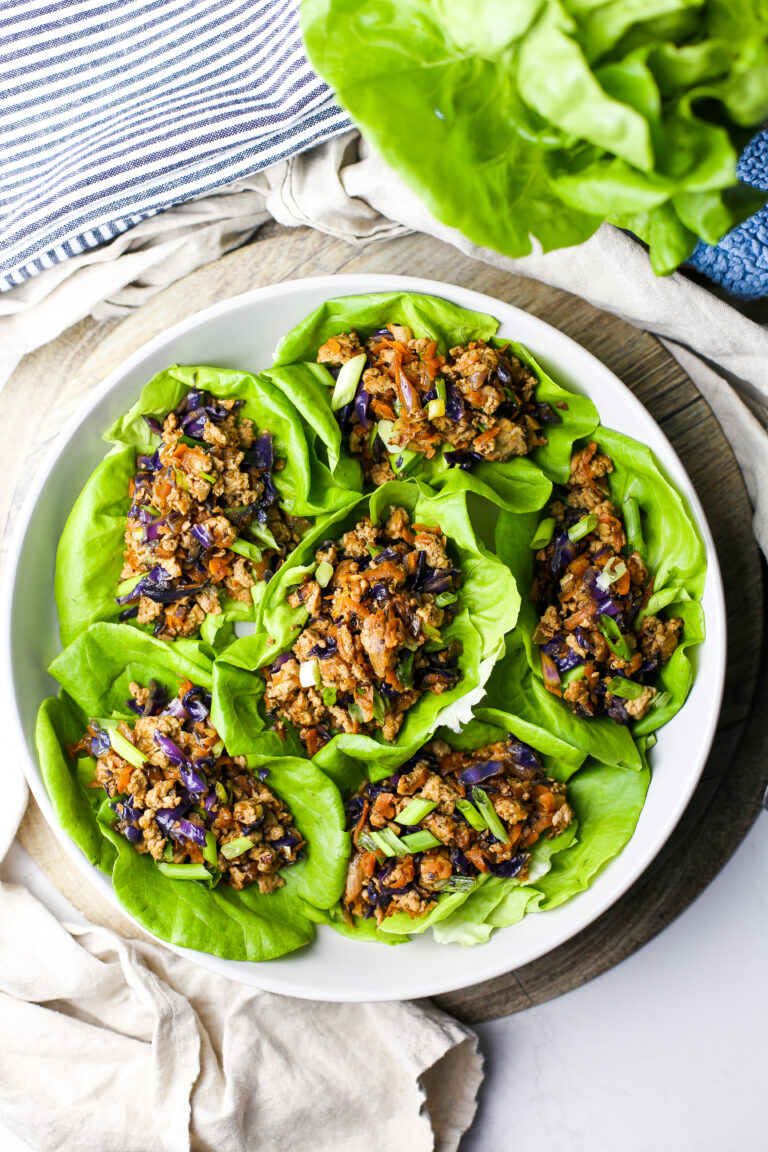 Overhead view of ground chicken lettuce wraps in a round grey bowl.