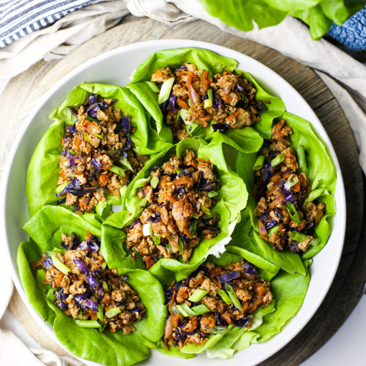 Overhead view of ground chicken lettuce wraps in a round grey bowl.