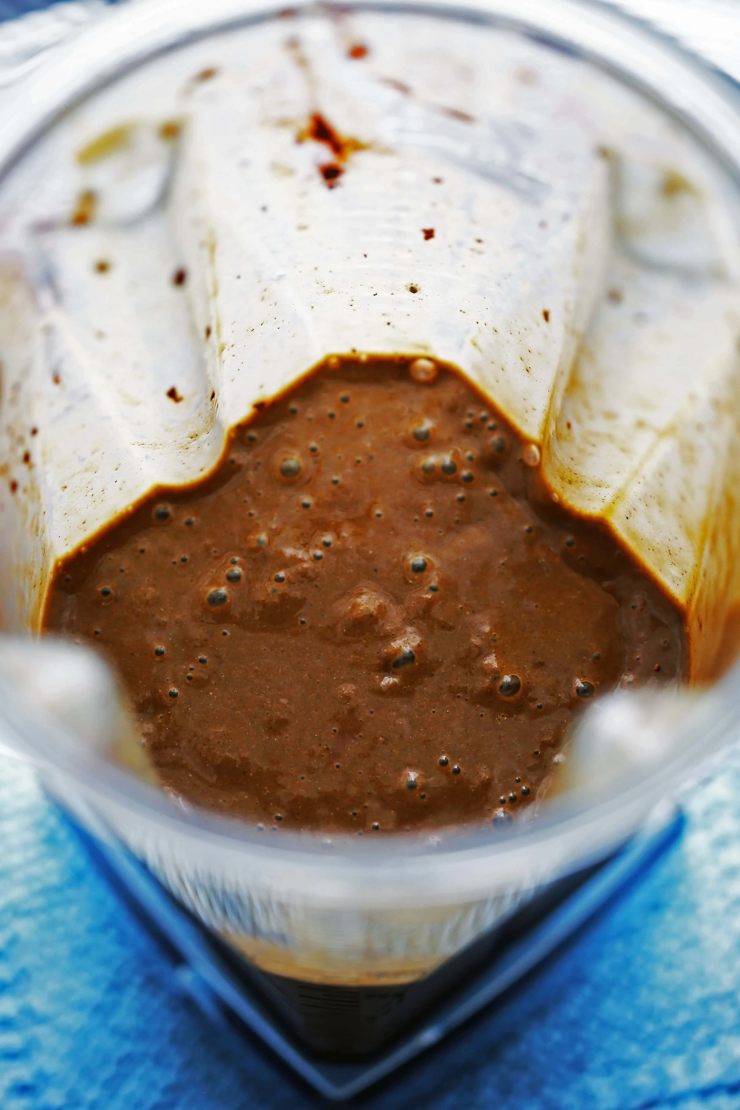 Healthy chocolate banana smoothie in a blender container.