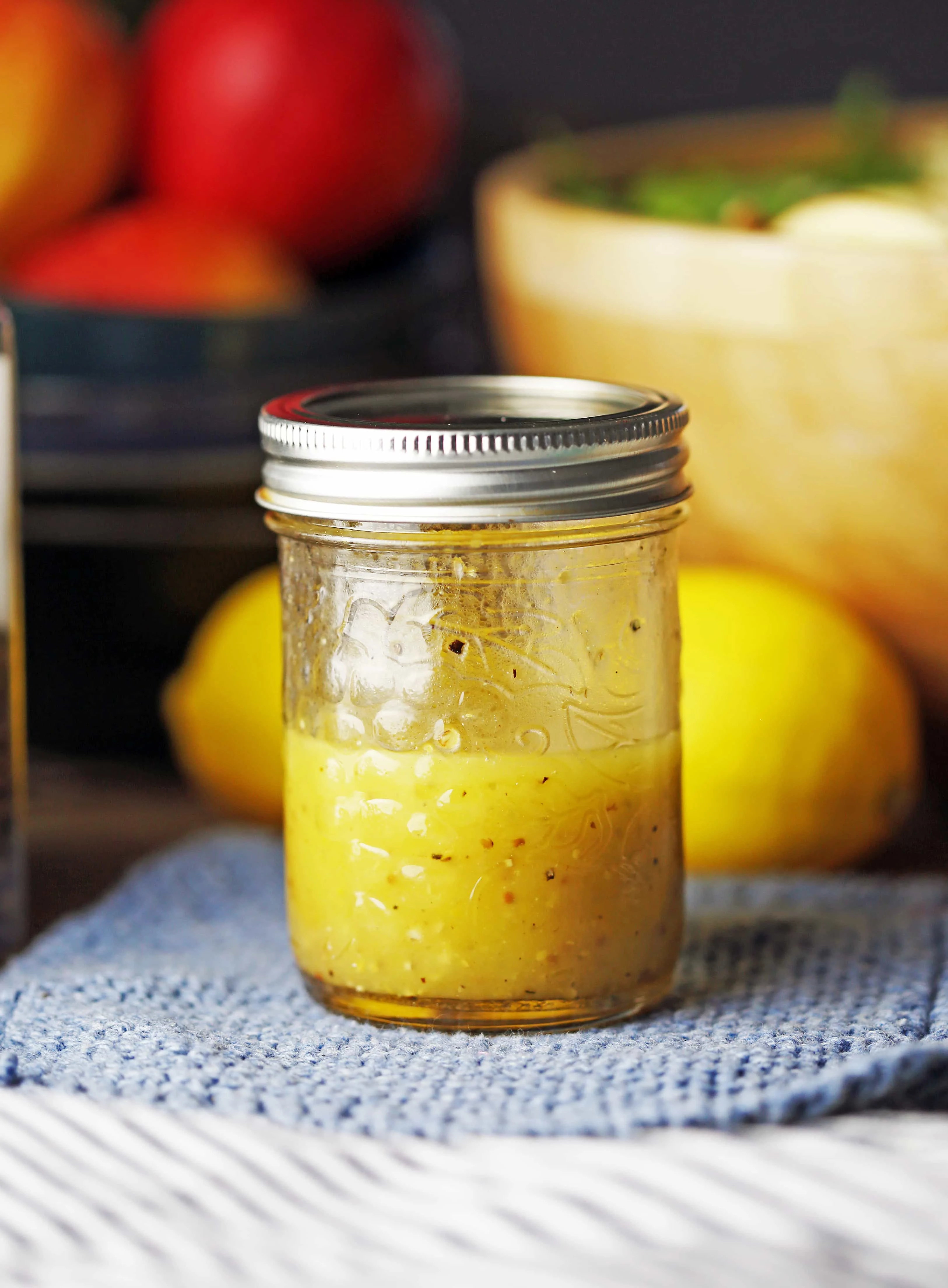 A small mason jar containing honey lemon vinaigrette.