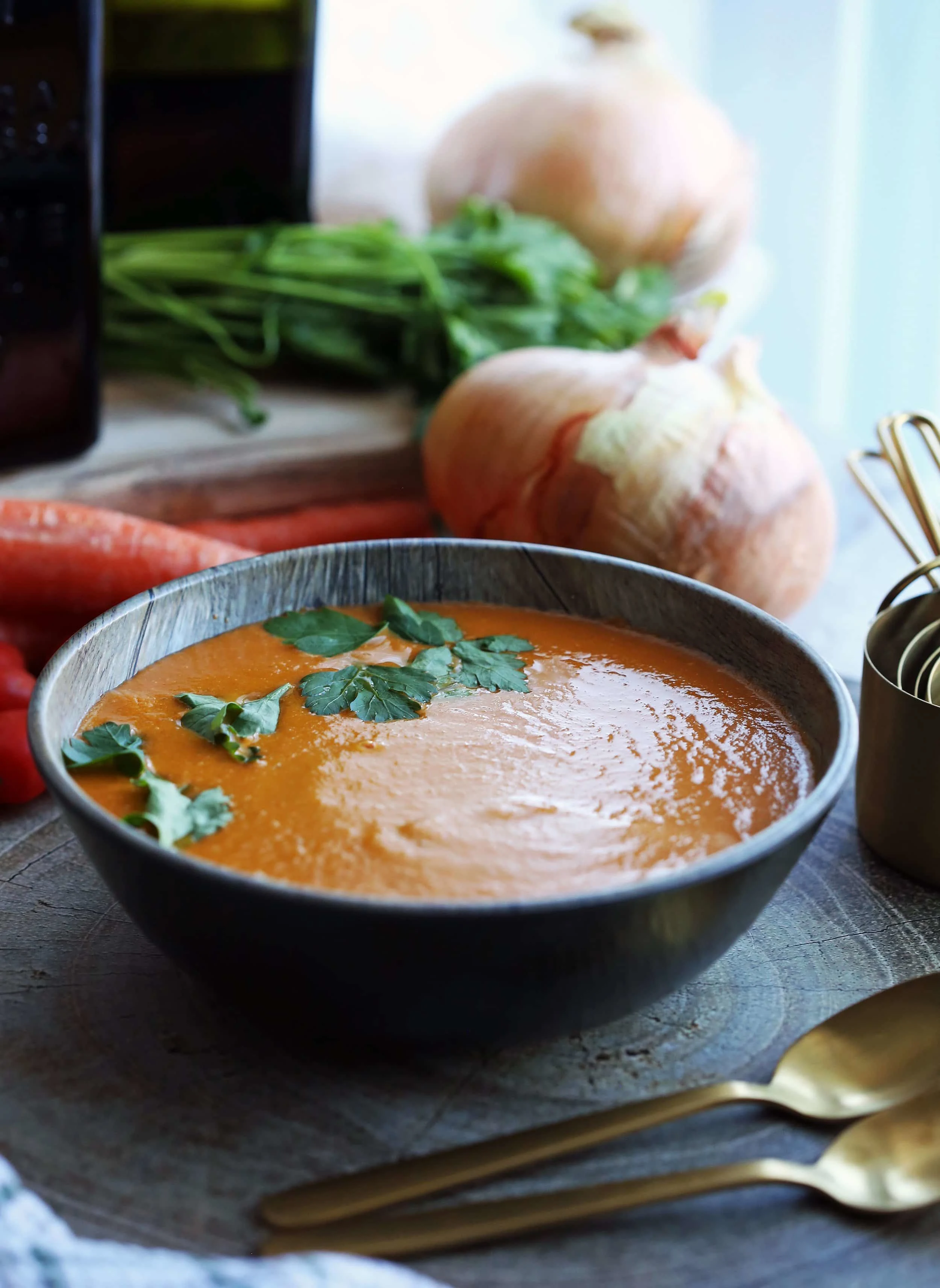 Homemade blended tomato soup that was made in the Instant Pot in a wooden bowl.