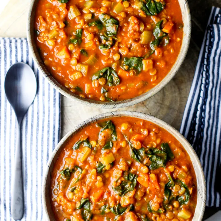 Overhead view of two bowls of Instant Pot Turmeric Lentil Soup.