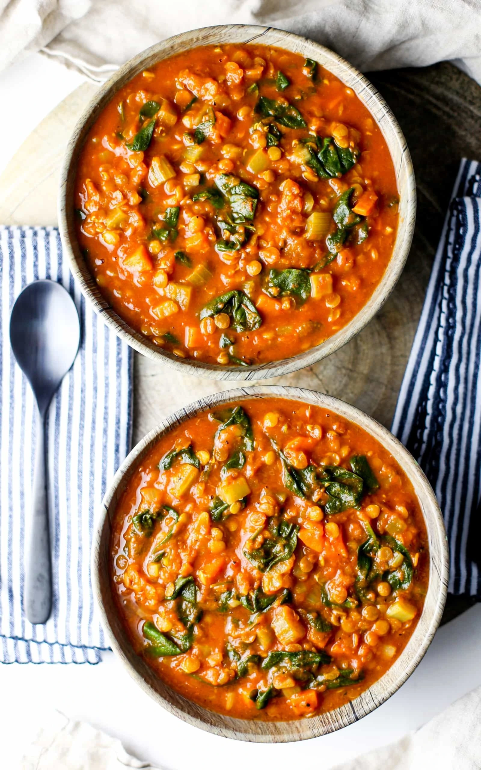 Overhead view of two bowls of Instant Pot Turmeric Lentil Soup.