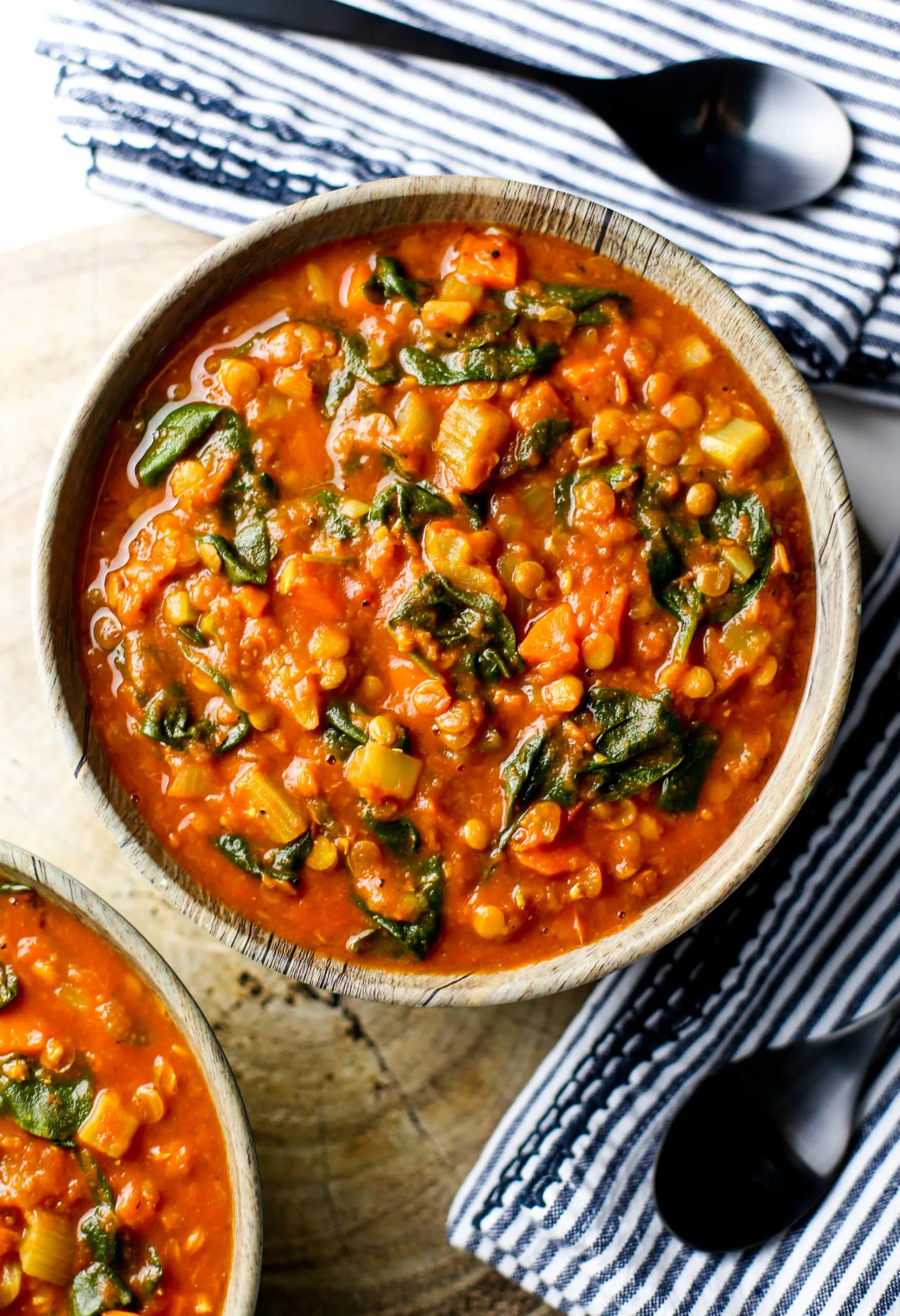 An overhead view of a bowl of Instant Pot Lentil Soup with turmeric and spinach.