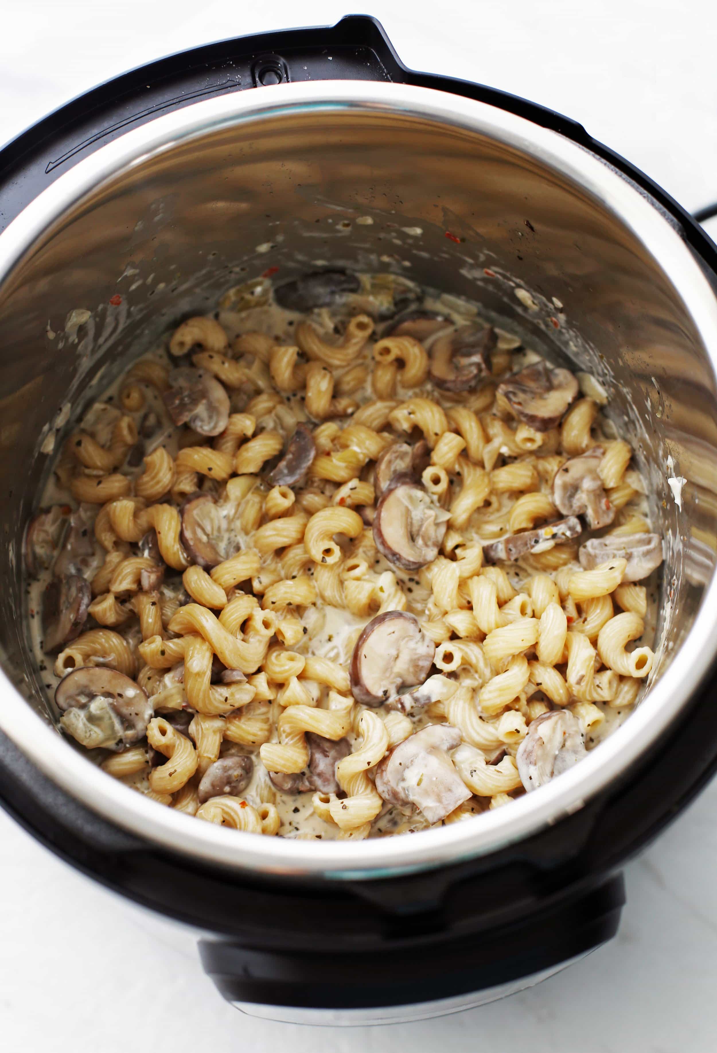 Pasta with brown mushrooms, creamy parmesan sauce, and dried herbs in the Instant Pot.