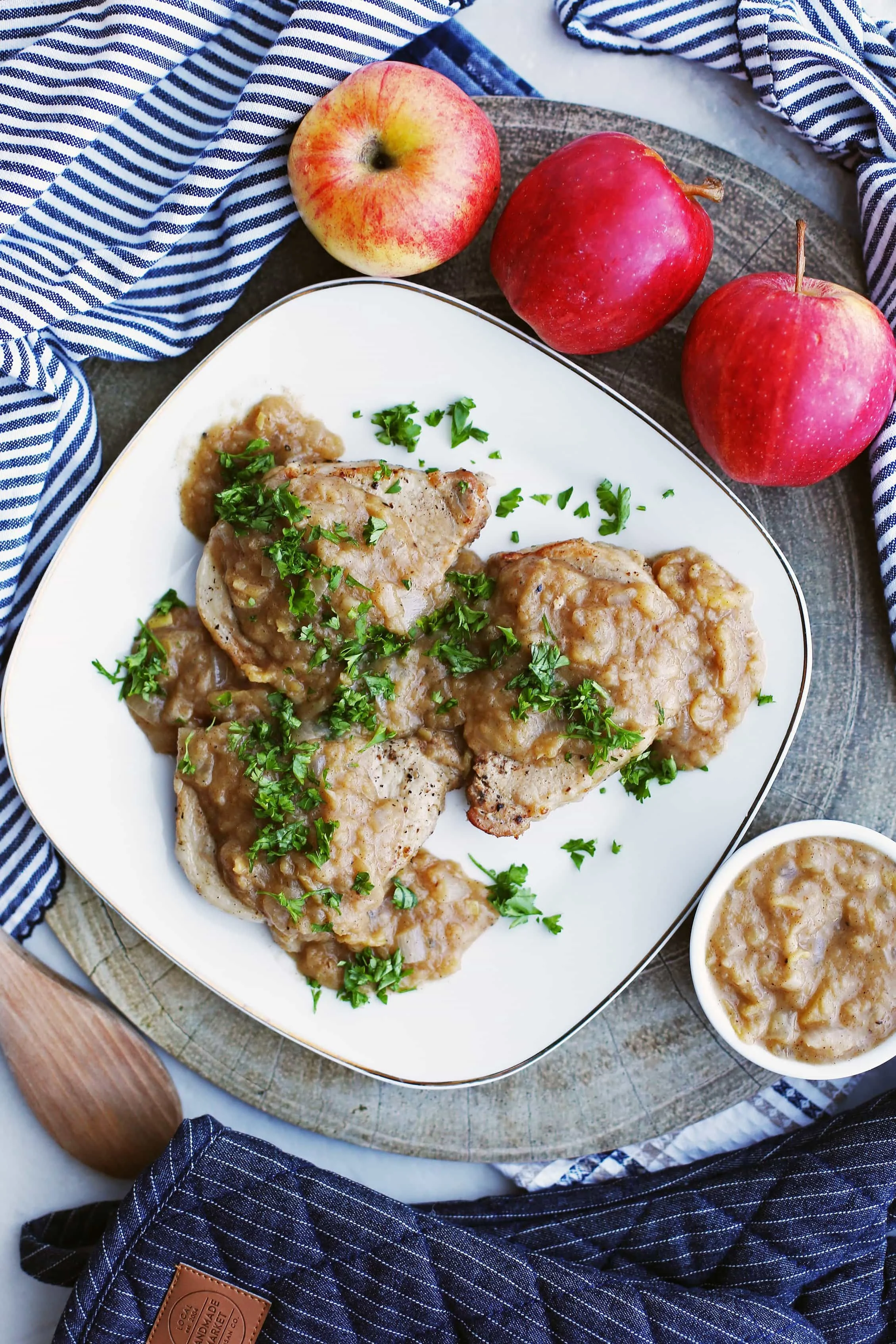 Overhead view of Instant Pot Pork Chops with Onion-Apple Sauce on a square white plate.