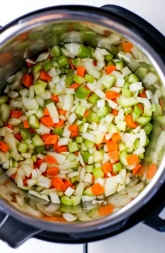 Sautéed diced carrots, onions, and celery in the Instant Pot.