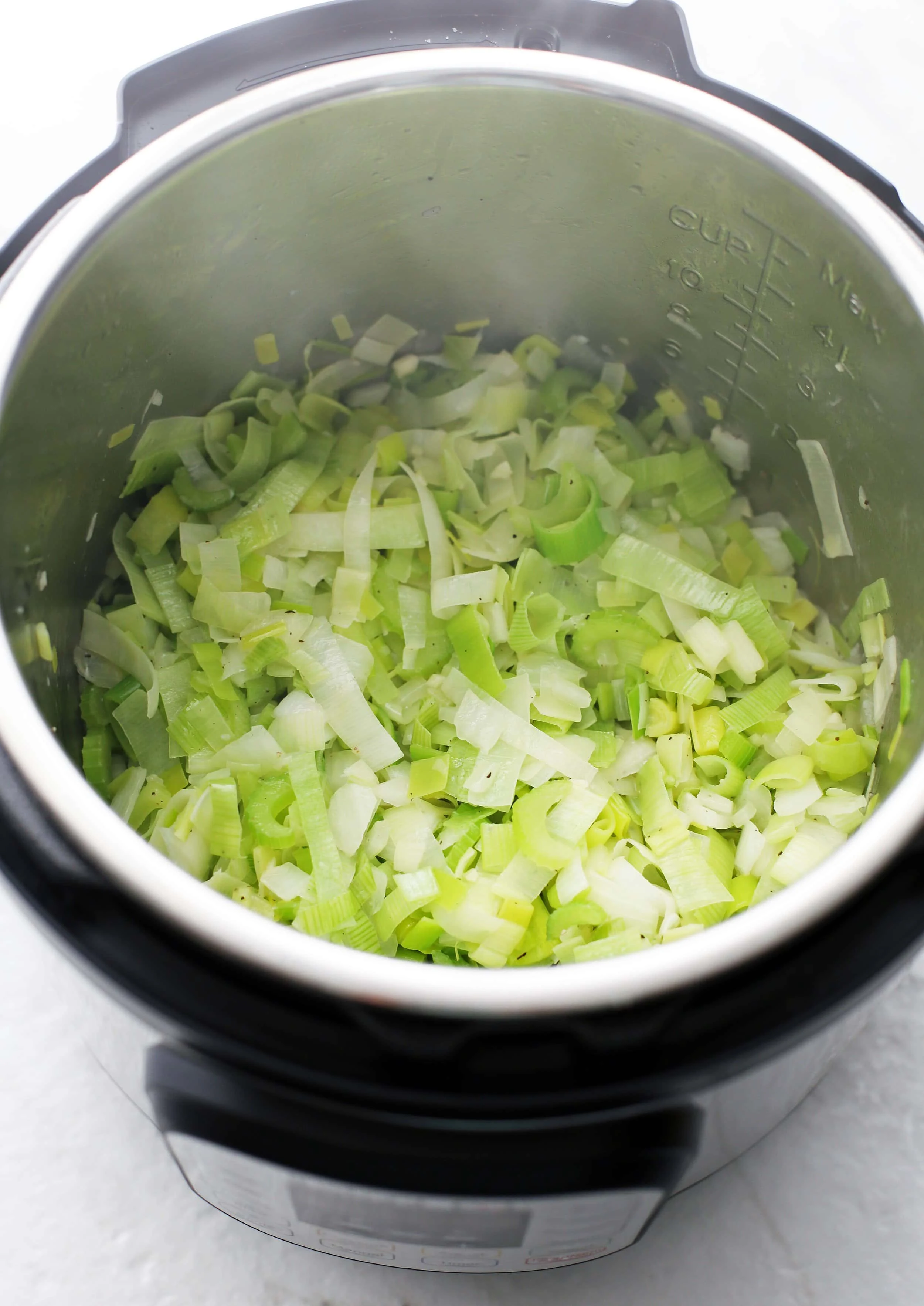 Sautéed chopped leeks, onions, celery, and garlic in the Instant Pot.