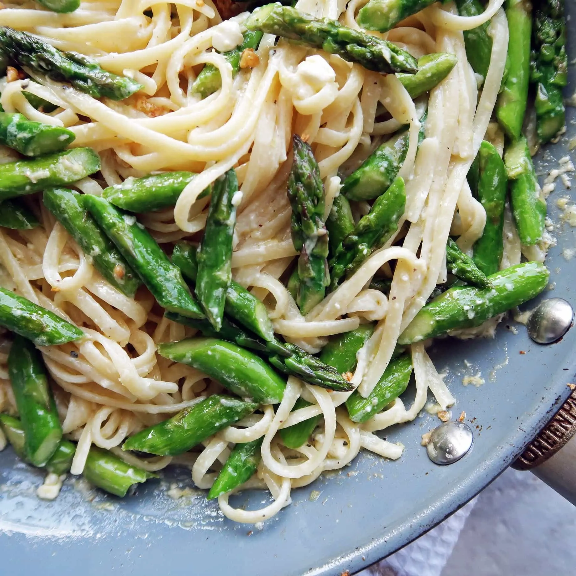 A pan of lemon feta linguine tossed with garlic asparagus.