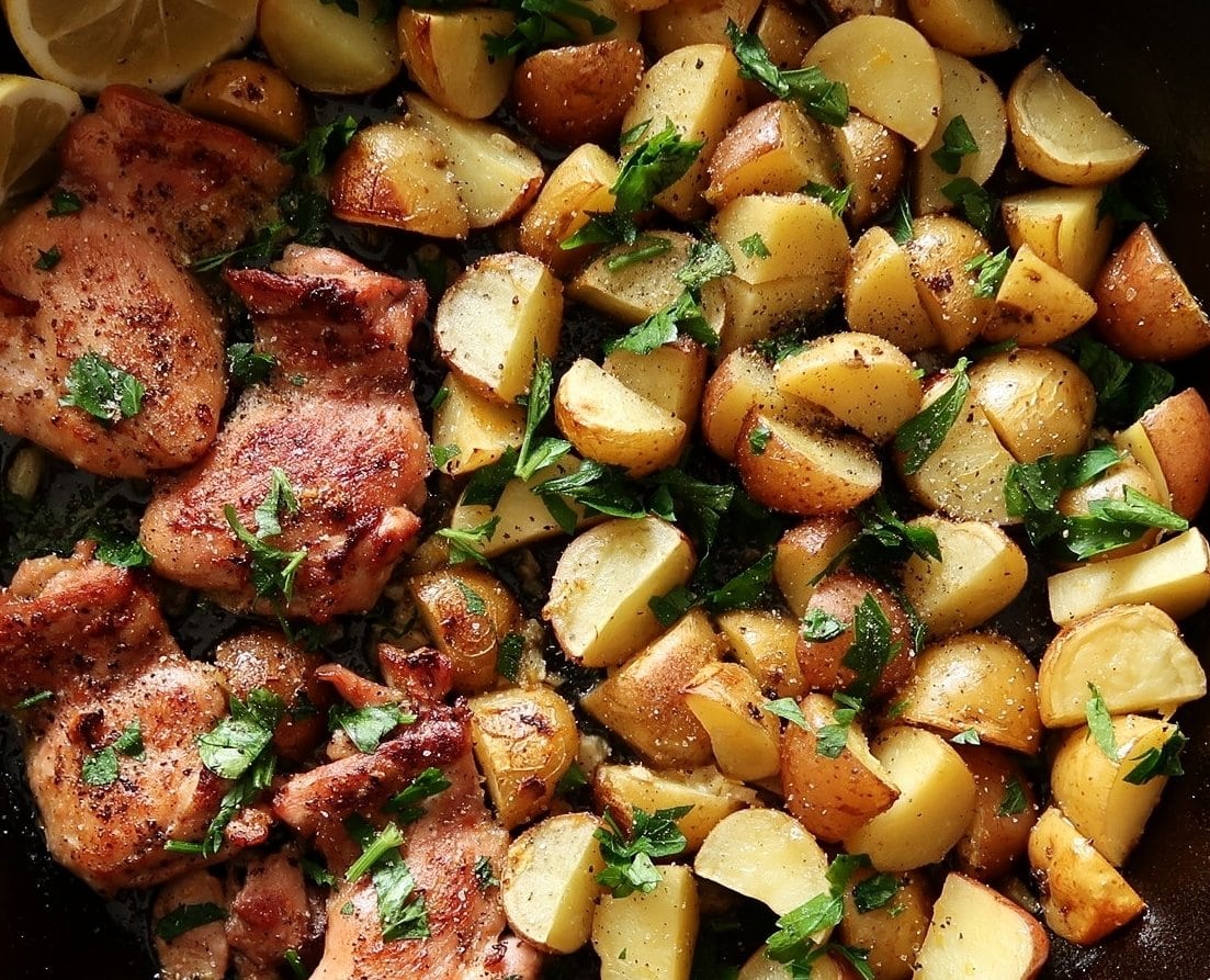 A close-up of Lemon Garlic Chicken with Baby Potatoes garnished with parsley.