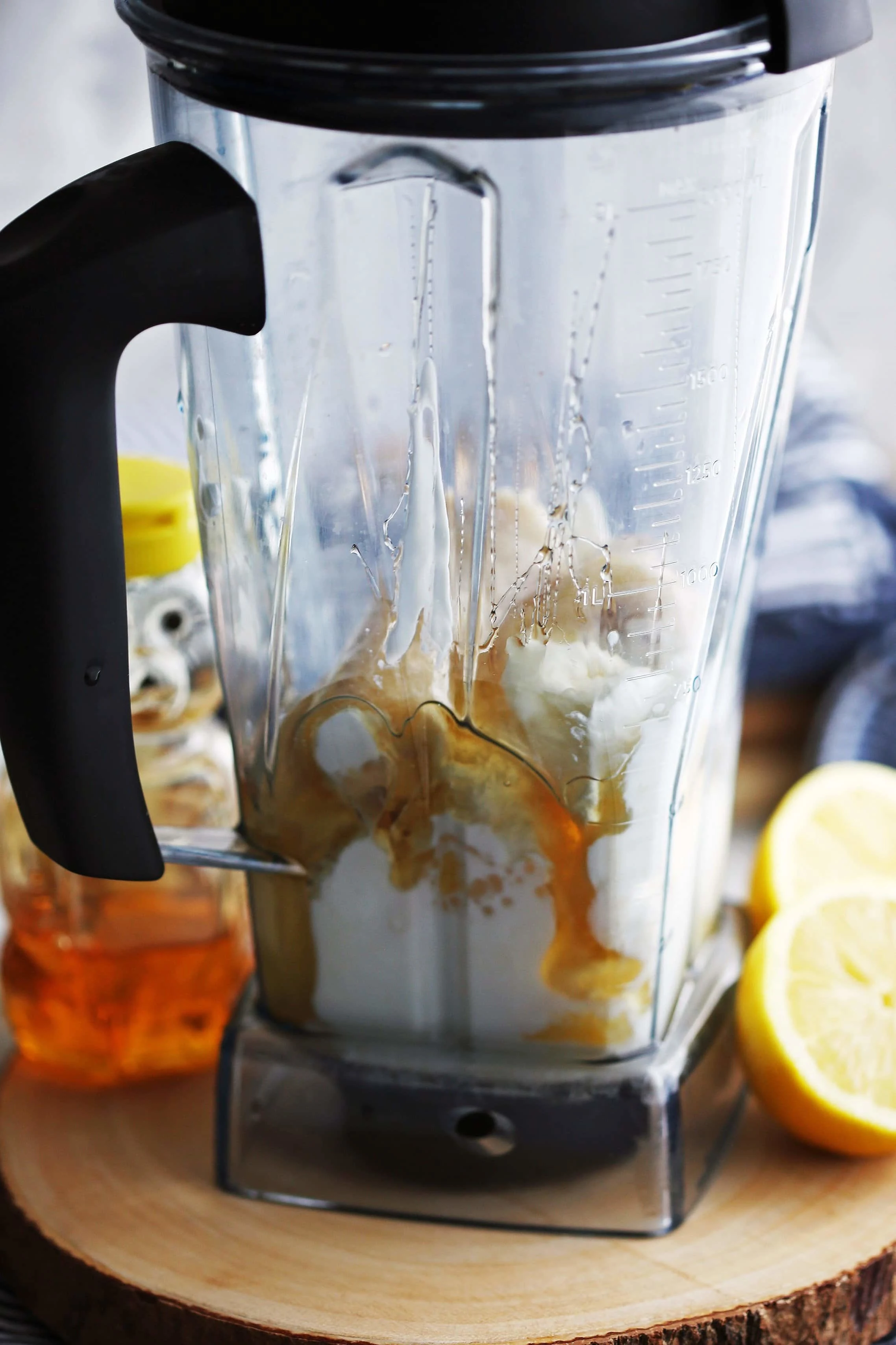 Lemon pineapple smoothie ingredients in a blender container.