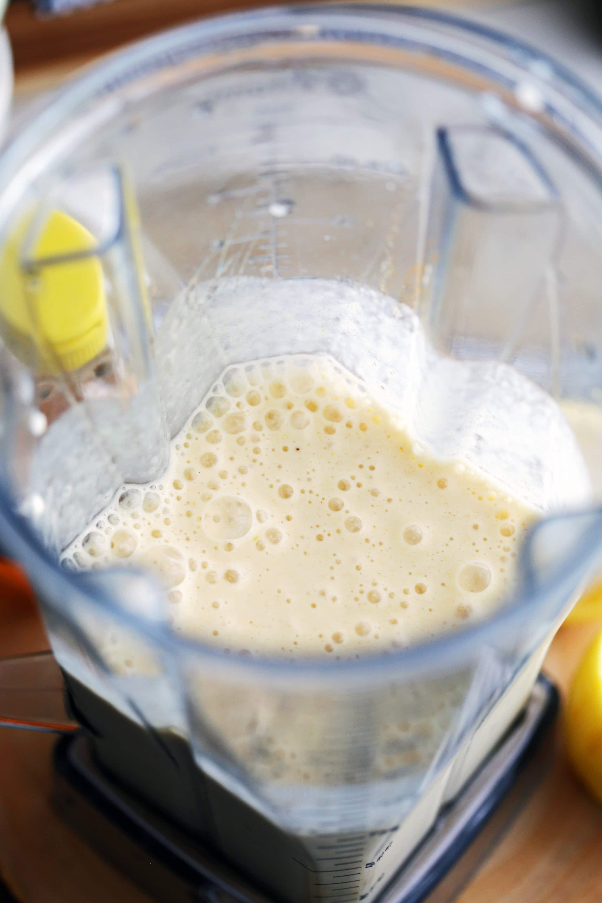 Creamy Lemon Pineapple Smoothie just blended in a large blender container.