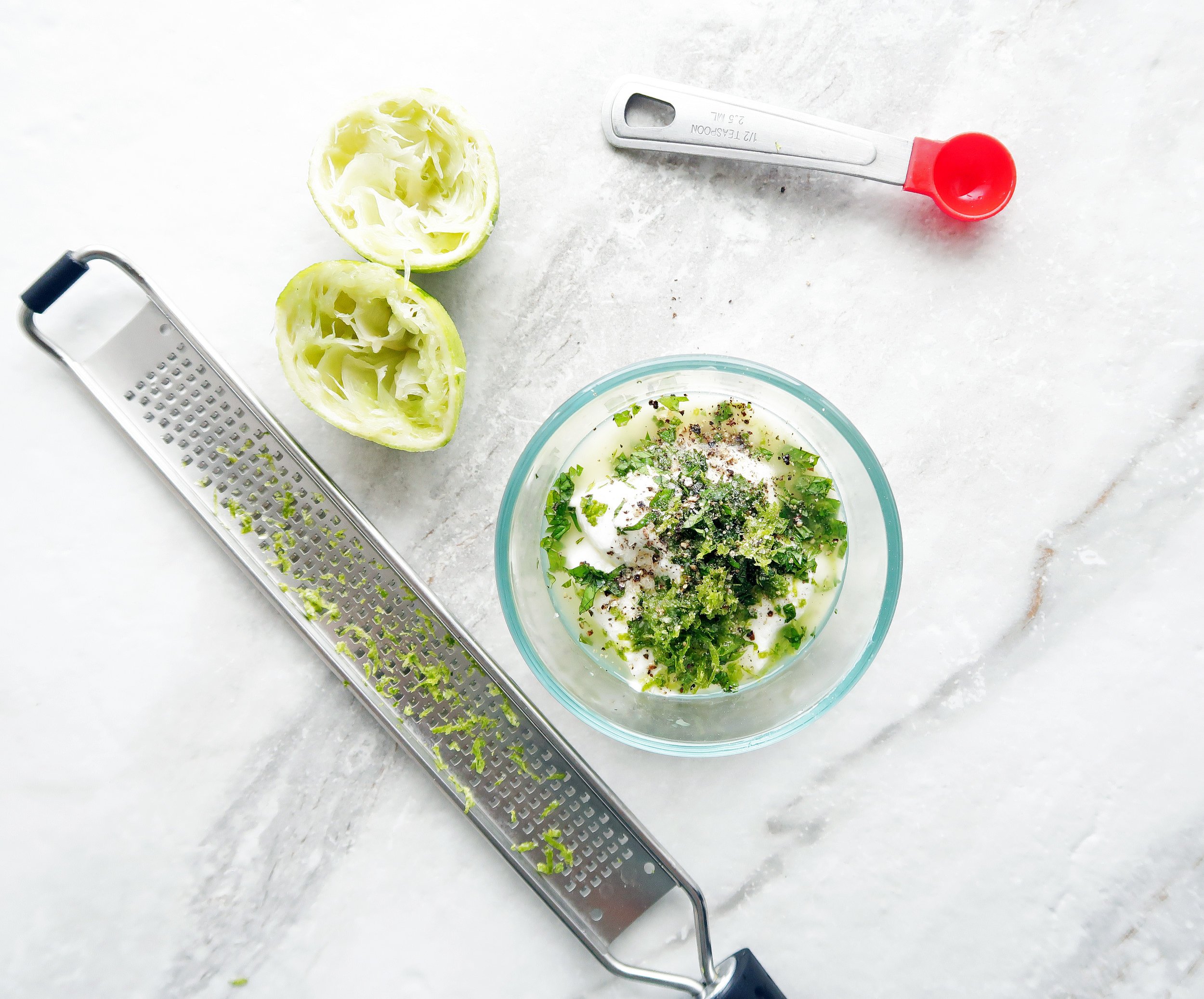 Lime-mint yogurt dressing ingredients in a bowl.