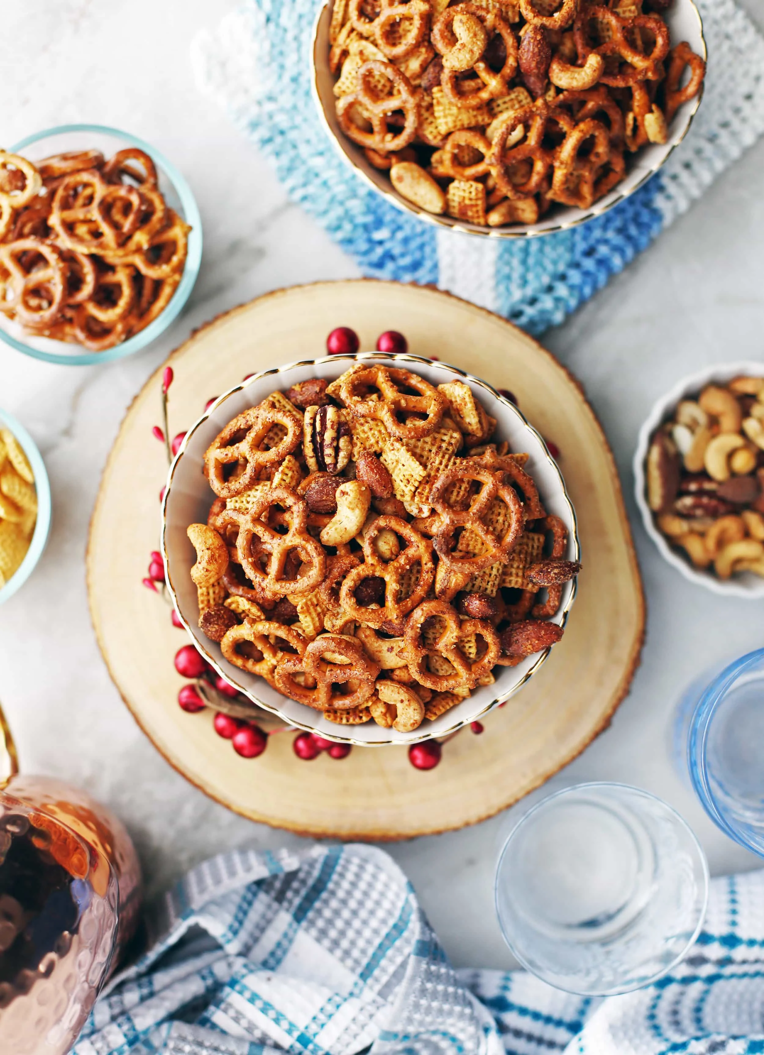 Overhead shot of two filled bowls of Maple Chili Nuts and Chex Snack Mix.