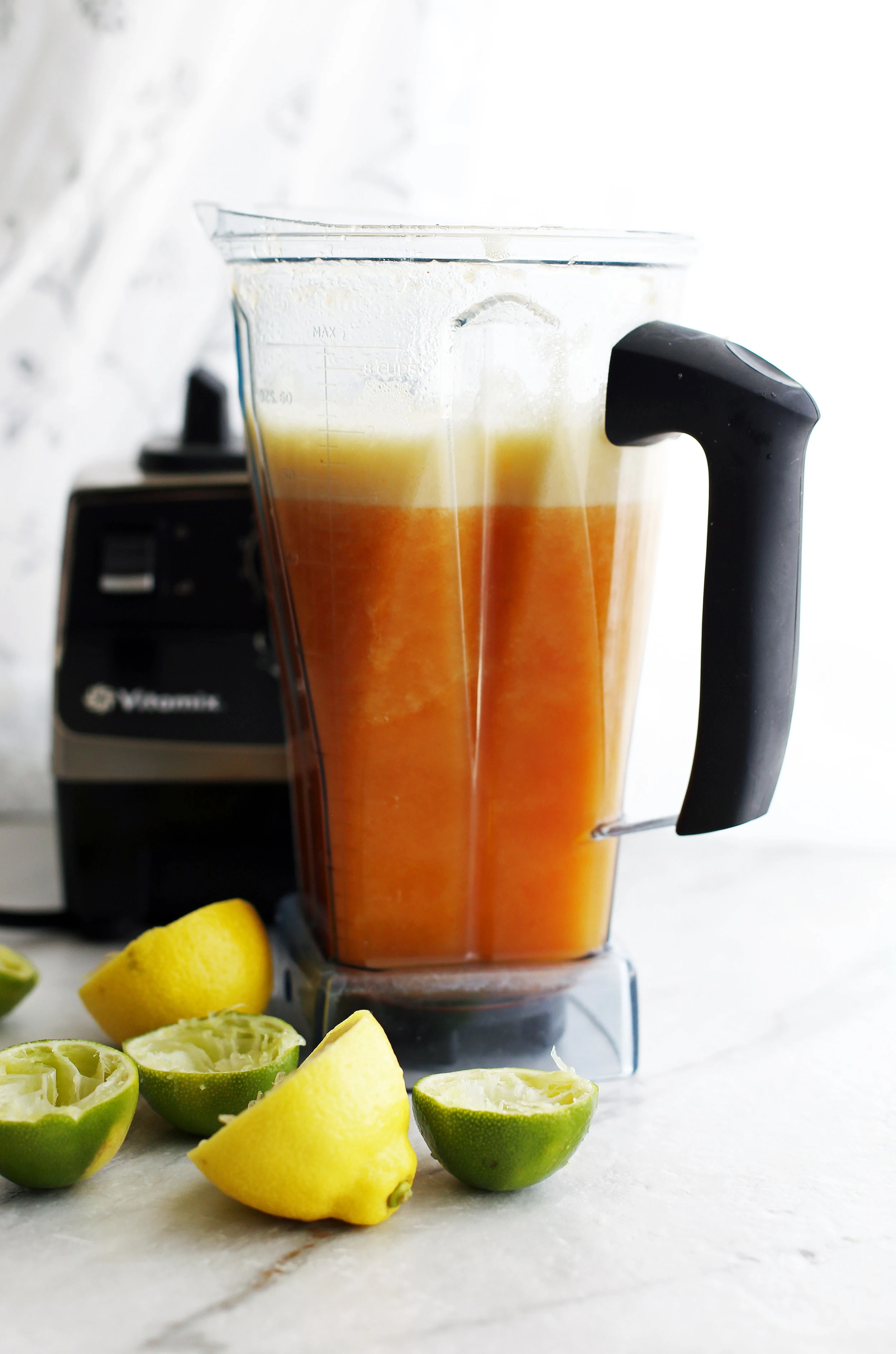 Newly made maple peach citrus juice in a blender container.