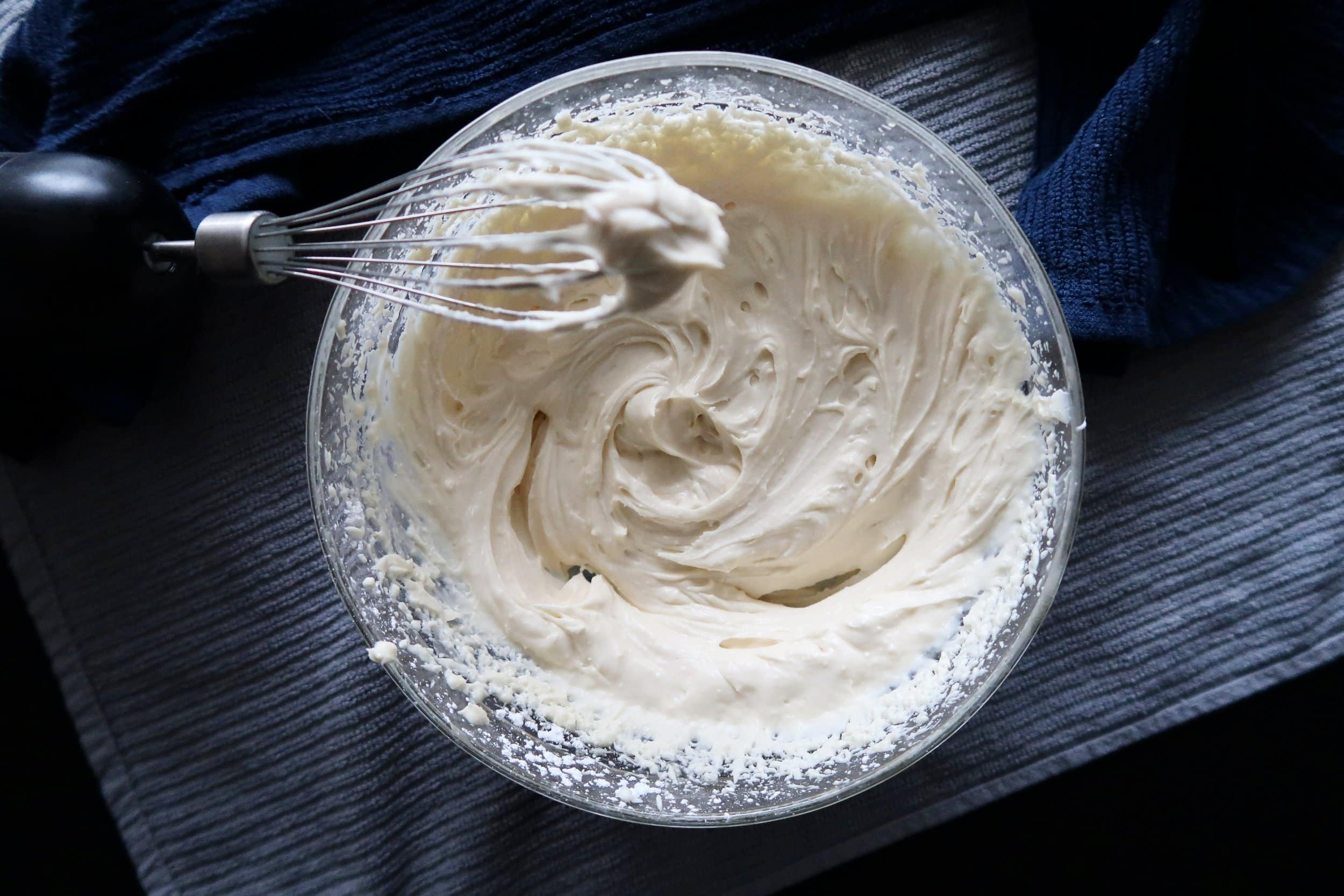 Maple cream cheese frosting in a mixing bowl.