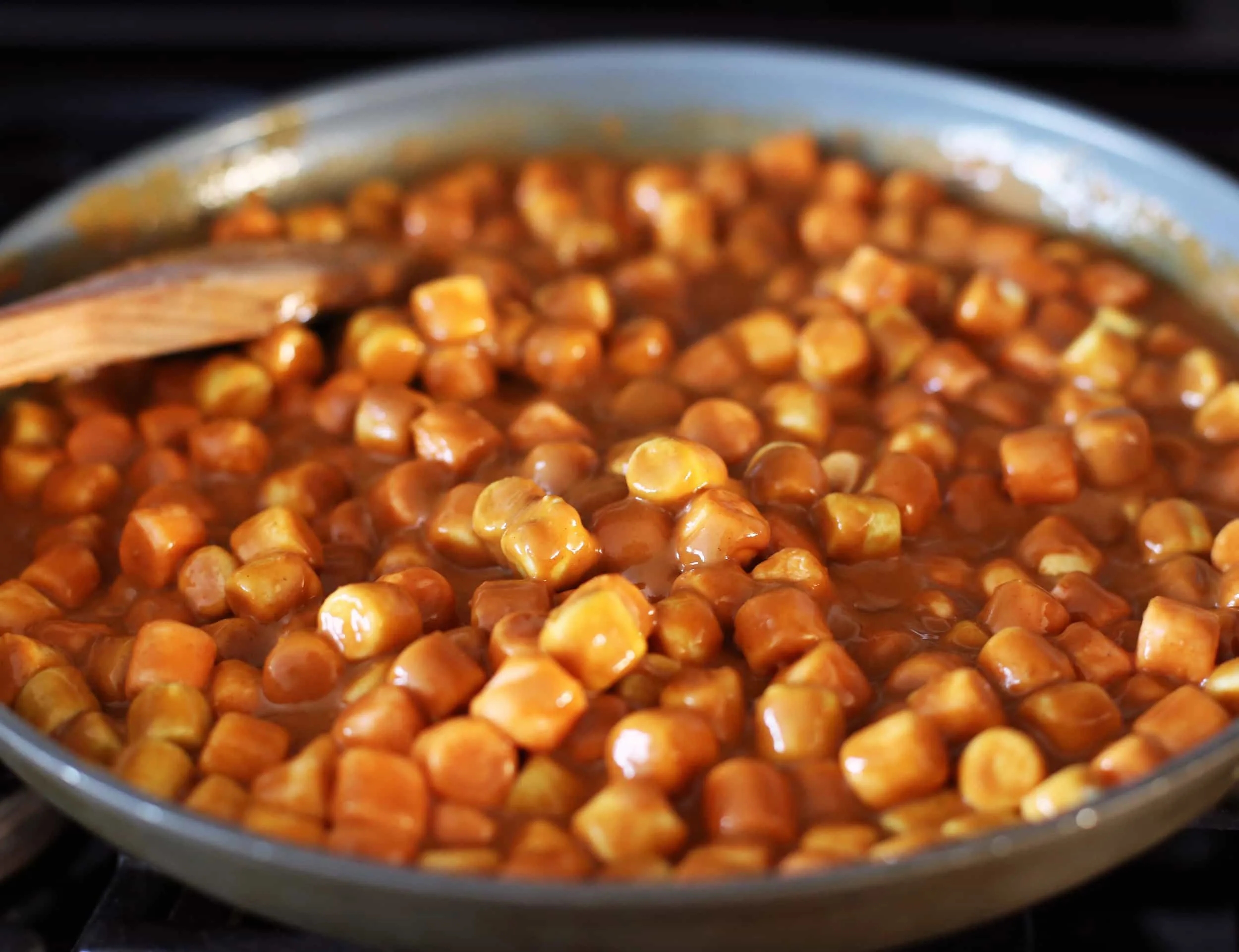 A mixture of peanut butter, butter, butterscotch chips, and marshmallows in a large frying pan.