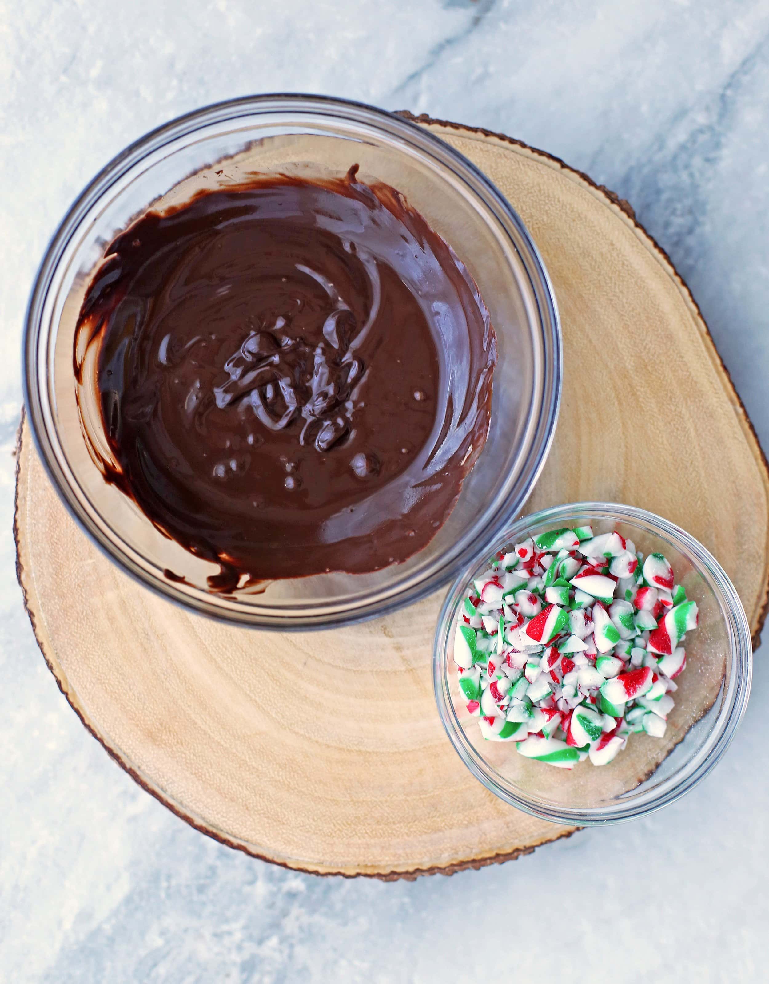 Melted milk chocolate and crushed candy canes divided into two glass bowls.