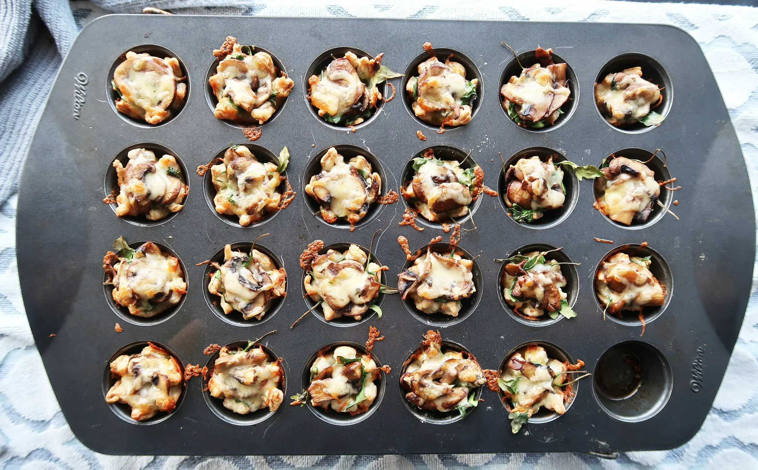 Mushroom Arugula Cheese Tarts in a muffin pan.