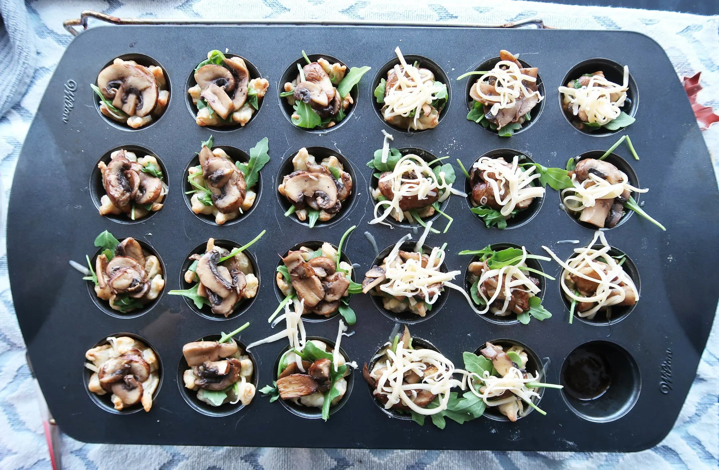 Mushroom arugula tarts topped with green onions and cheese.