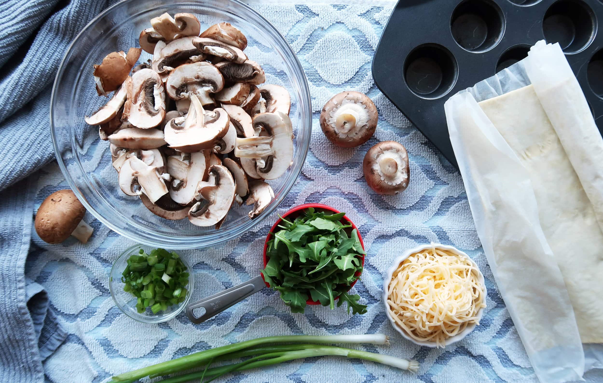 Mushrooms, green onions, arugula, and cheese.