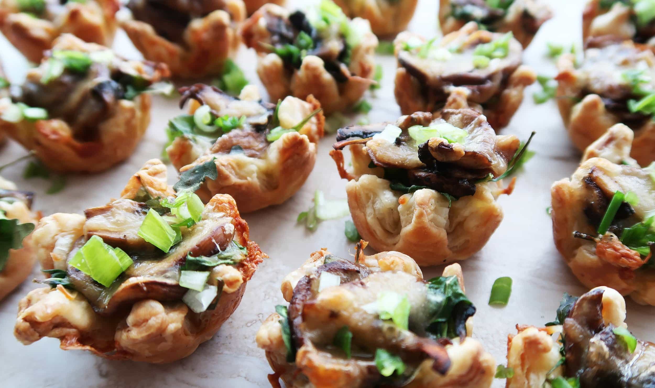 Mushroom Arugula Cheese Tarts arranged in rows.