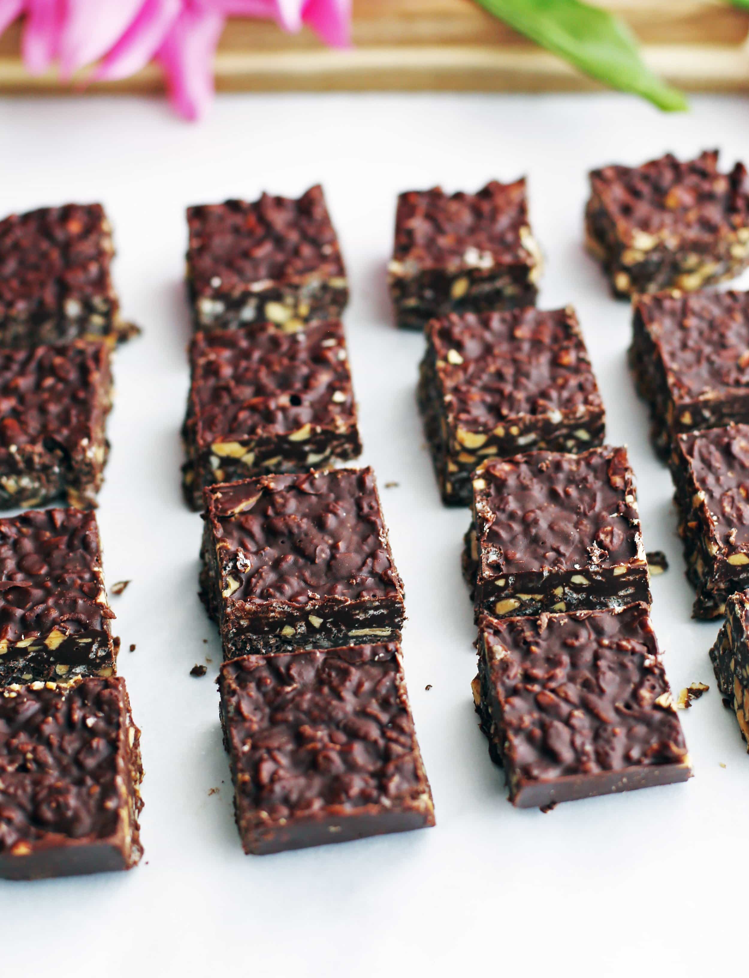 No-bake Peanut Butter Chocolate Crunch Bars on white parchment paper.