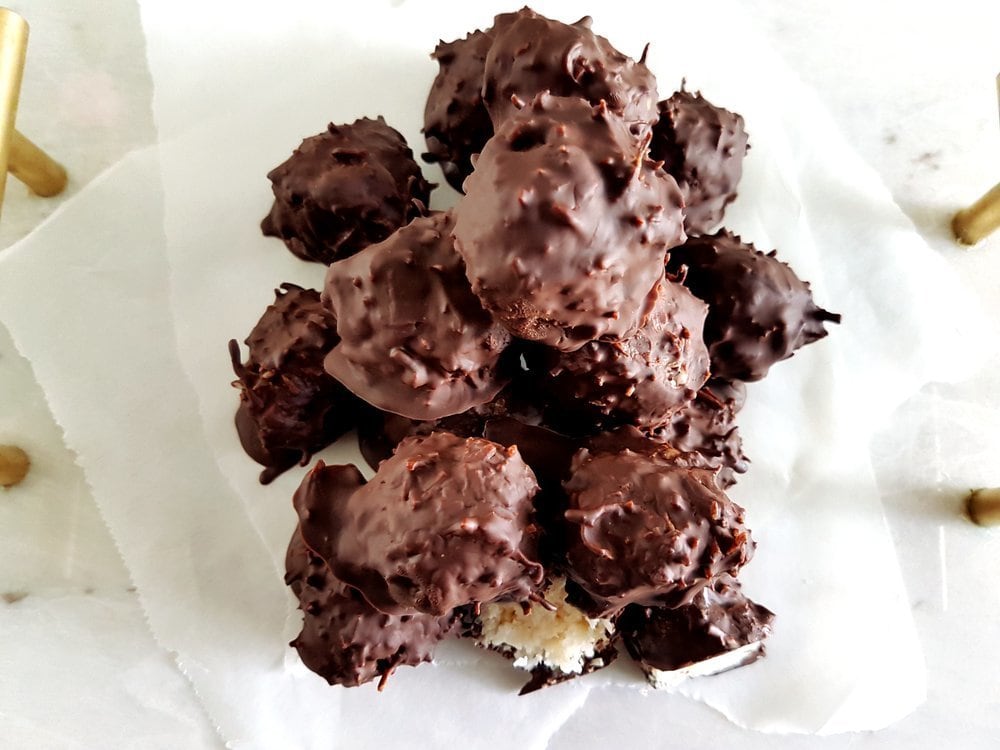 A stack of No-Bake Dark Chocolate Coconut Balls viewed from above.