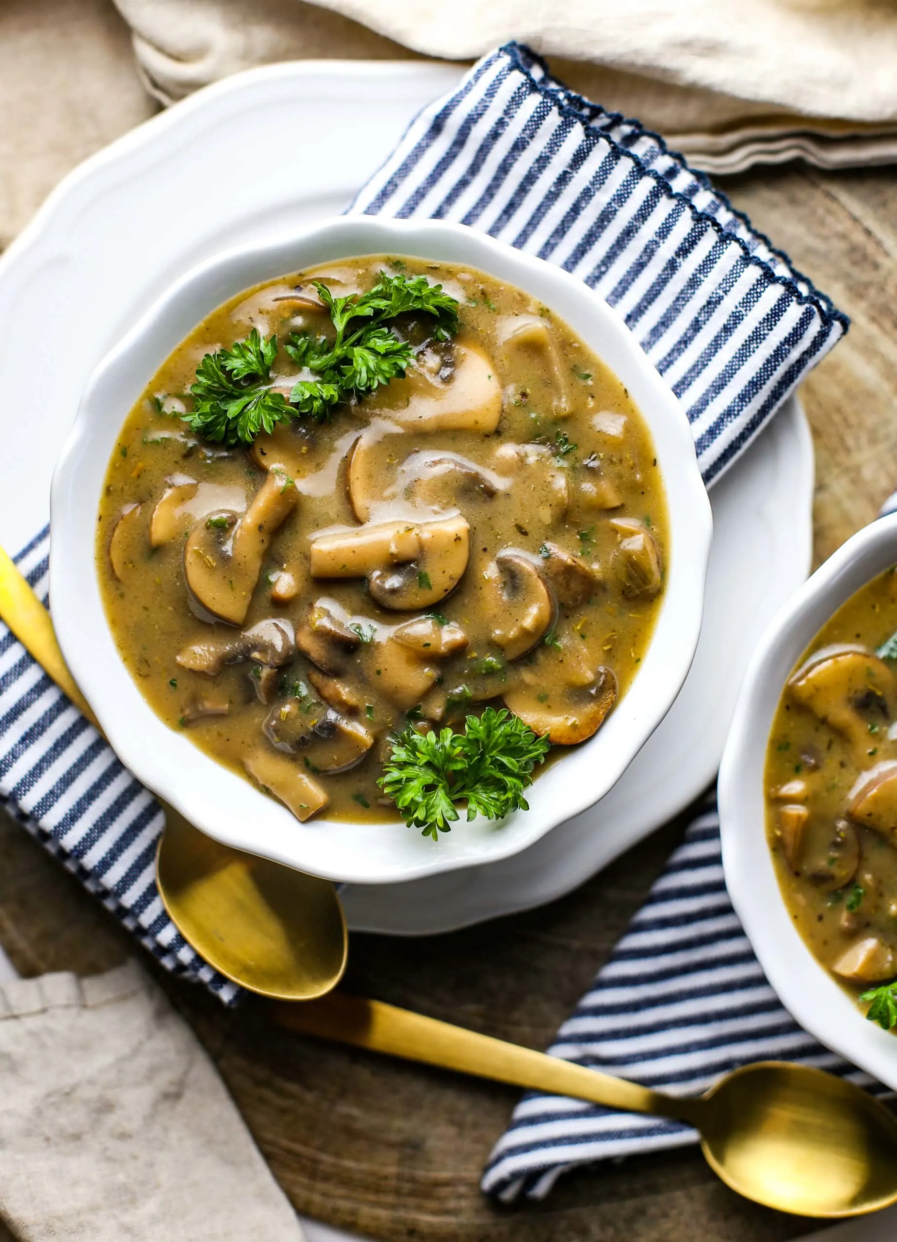 Overhead view of creamy vegan mushroom soup in a white bowl.