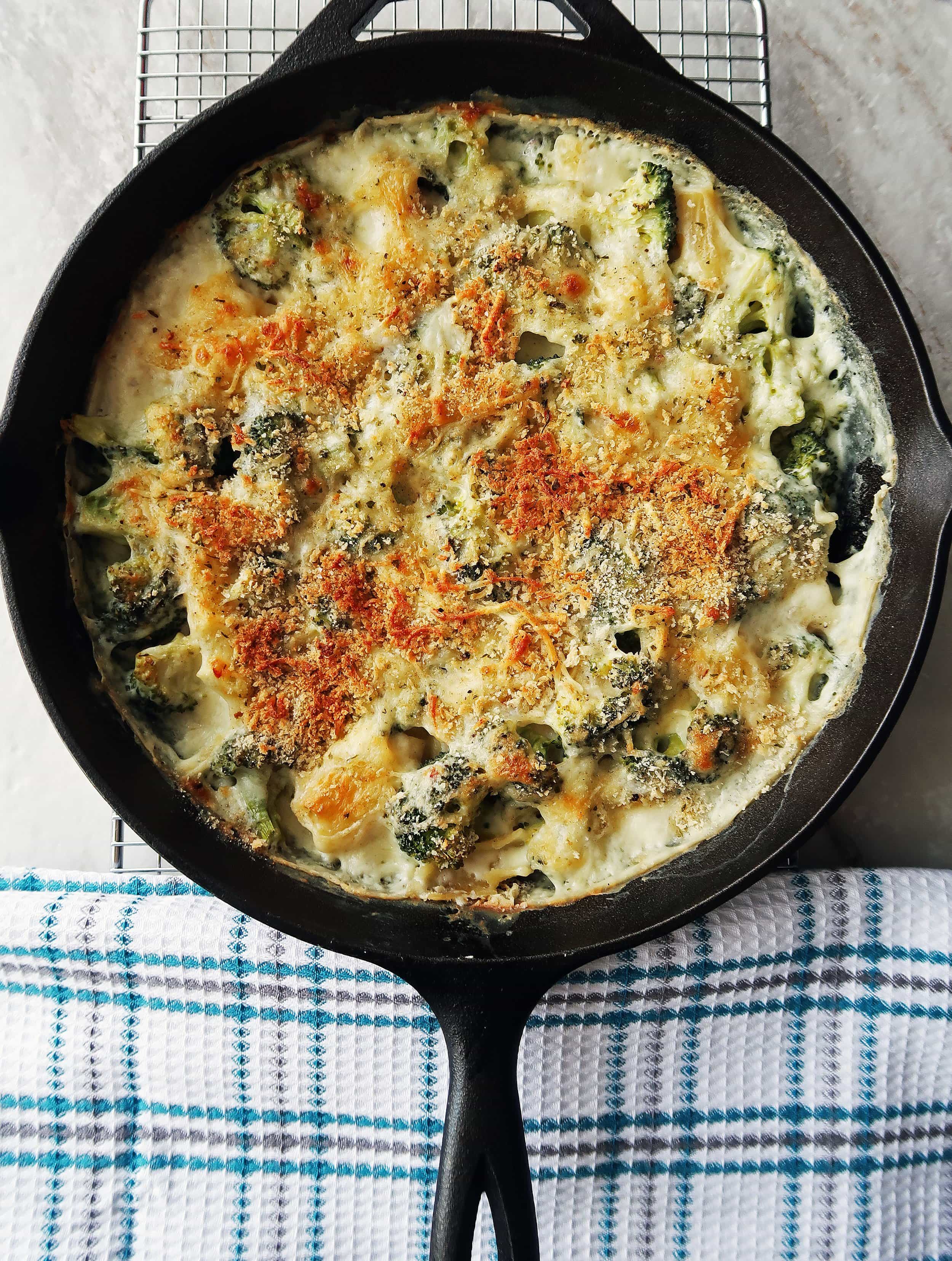 One Skillet Pasta Bake with Broccoli and White Cheese Sauce cooling on a rack.