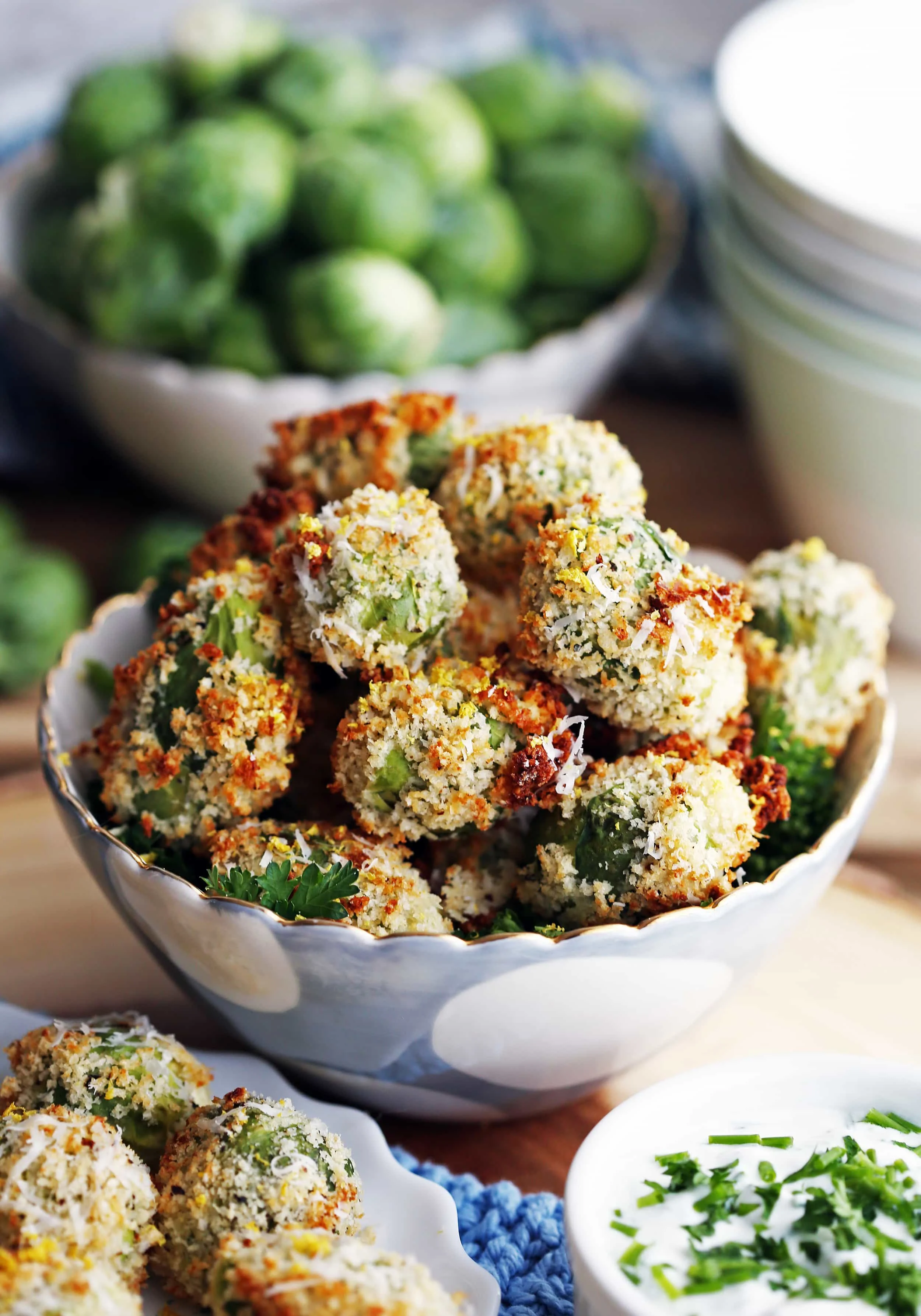 Baked parmesan Panko breadcrumb Brussels sprouts piled in a blue bowl.