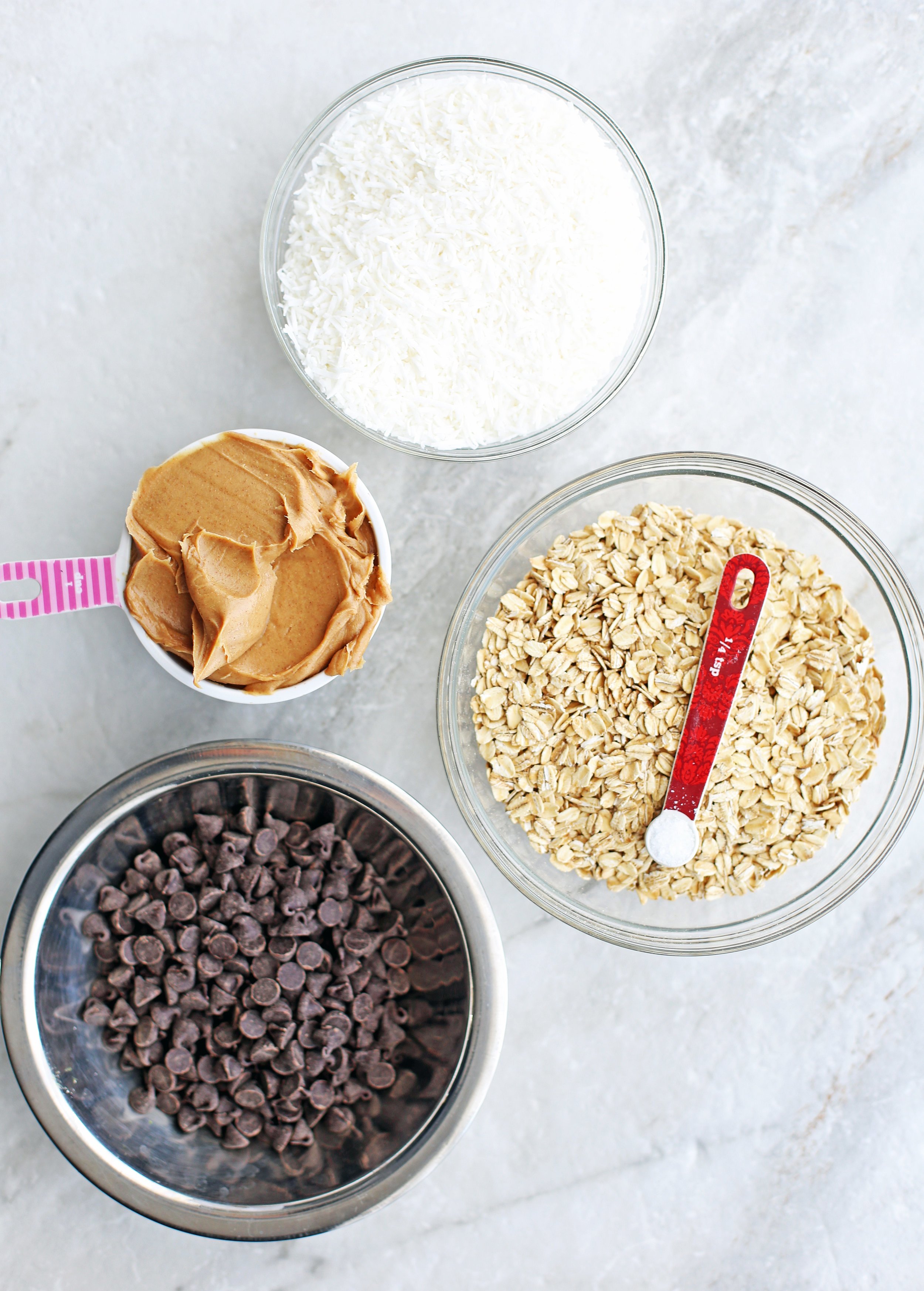 Bowls of chocolate chips, rolled oats, peanut butter, and sea salt.