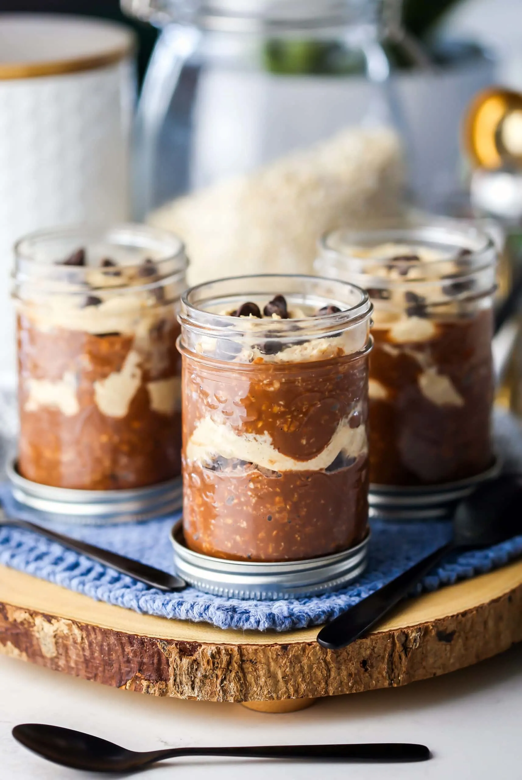 Side view of three mason jars filled with peanut butter mocha overnight oats.