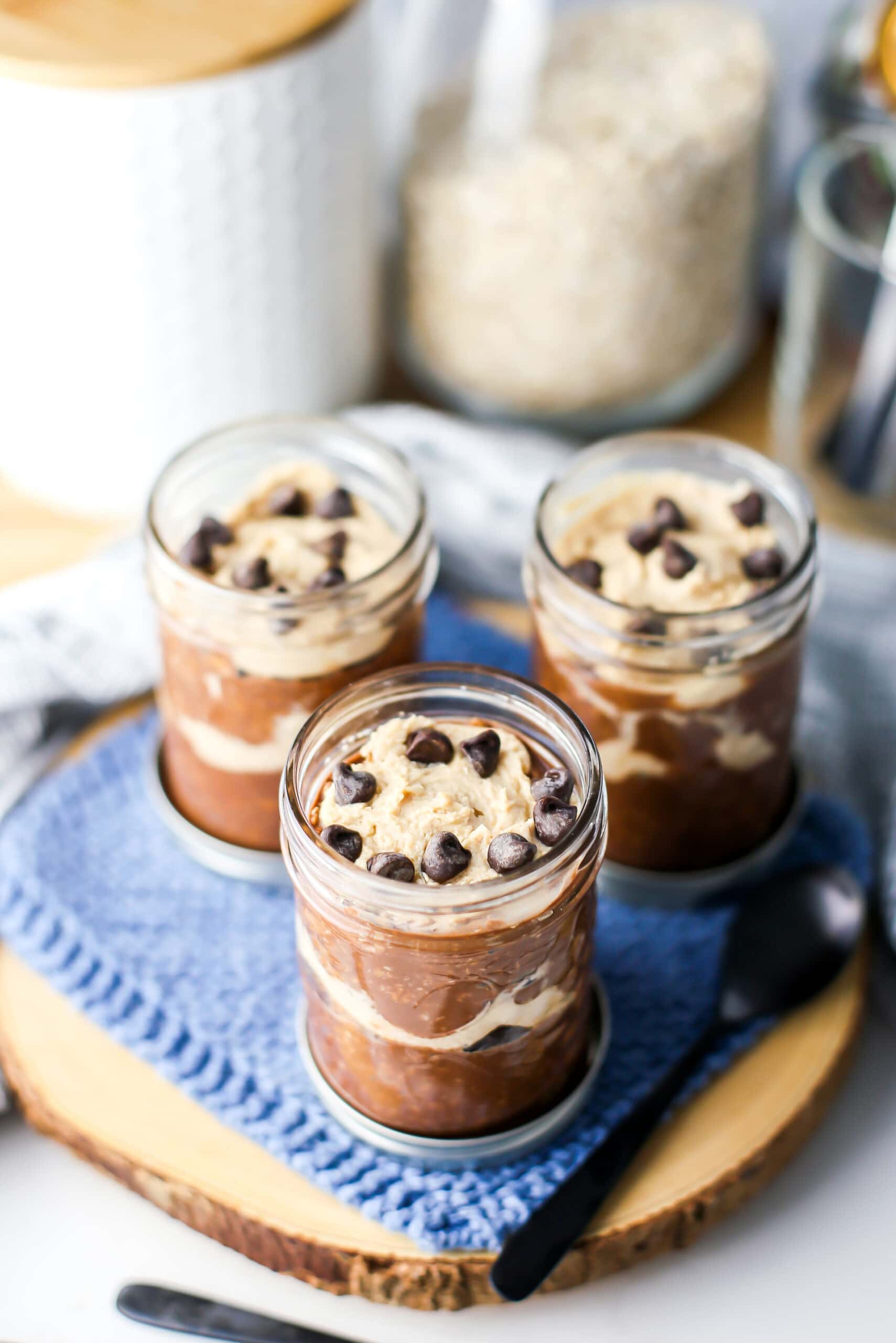 A top angled view of peanut butter mocha overnight oats in three mason jars.
