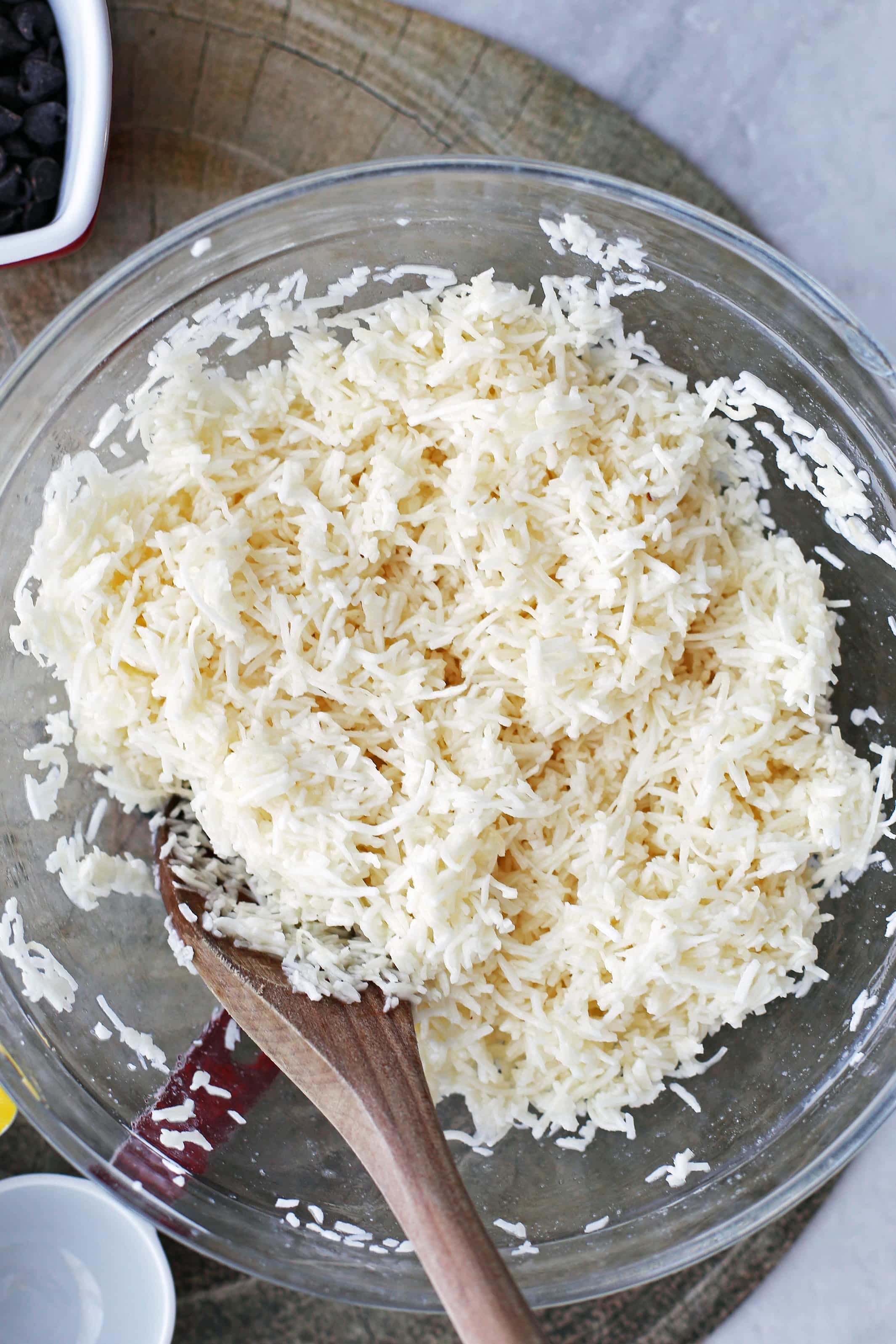 Shredded coconut, egg whites, sugar, peppermint extract, and salt in a large glass bowl.
