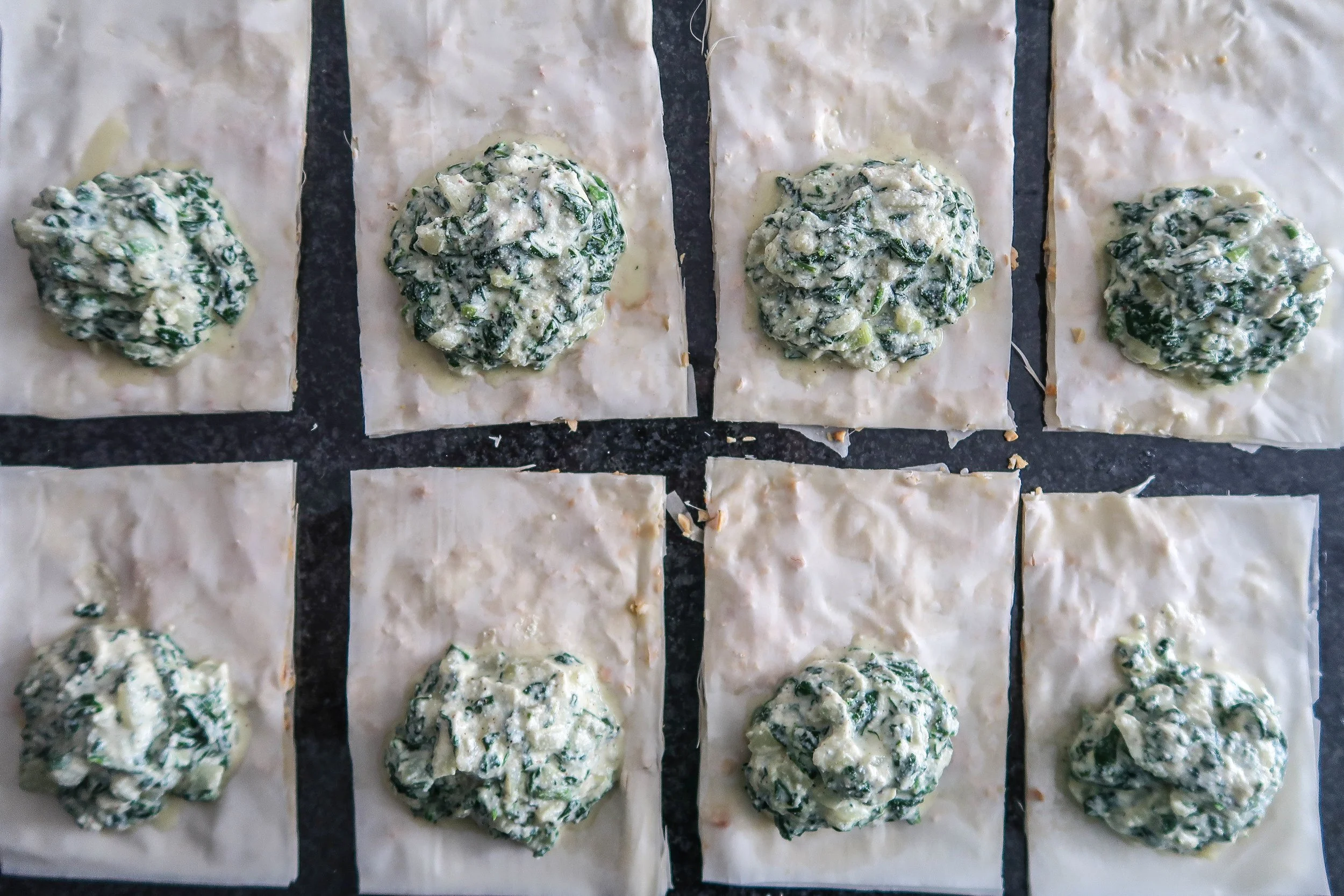 Phyllo dough rectangles with a dollop of spinach and ricotta filling.