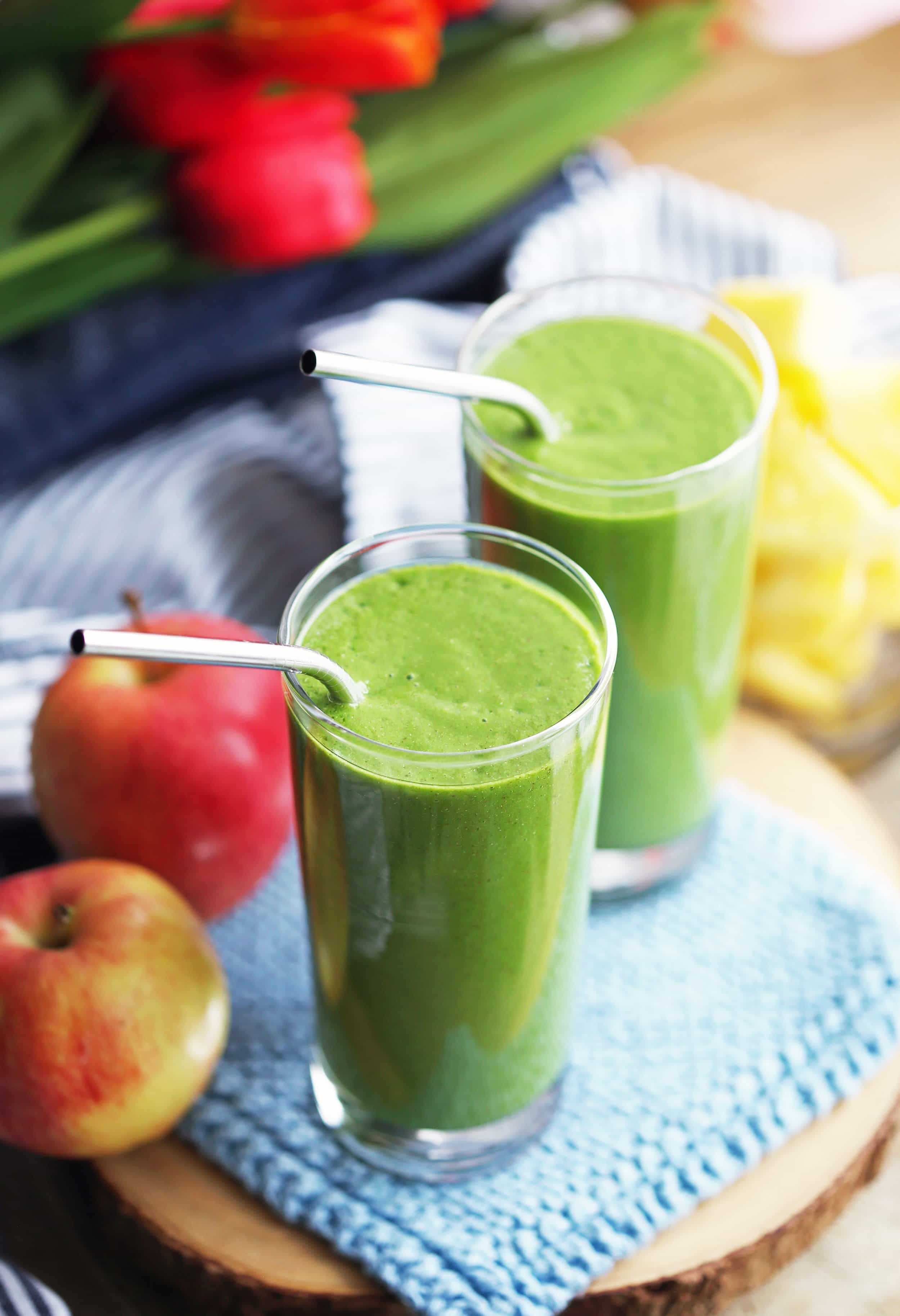 Two tall drinking glasses filled with Kale Pineapple Chia Smoothie.