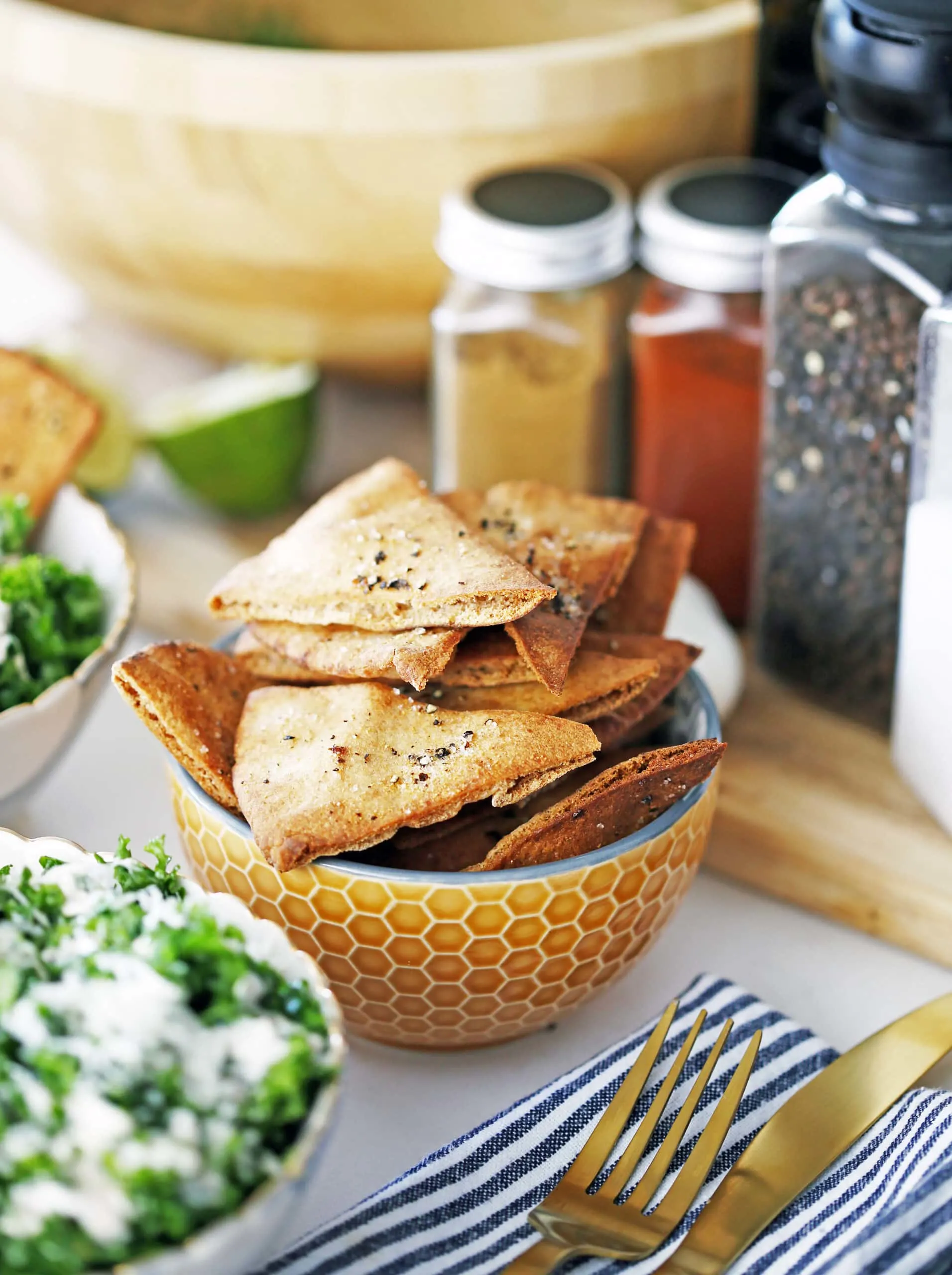 Crunchy homemade pita chips in an orange bowl.