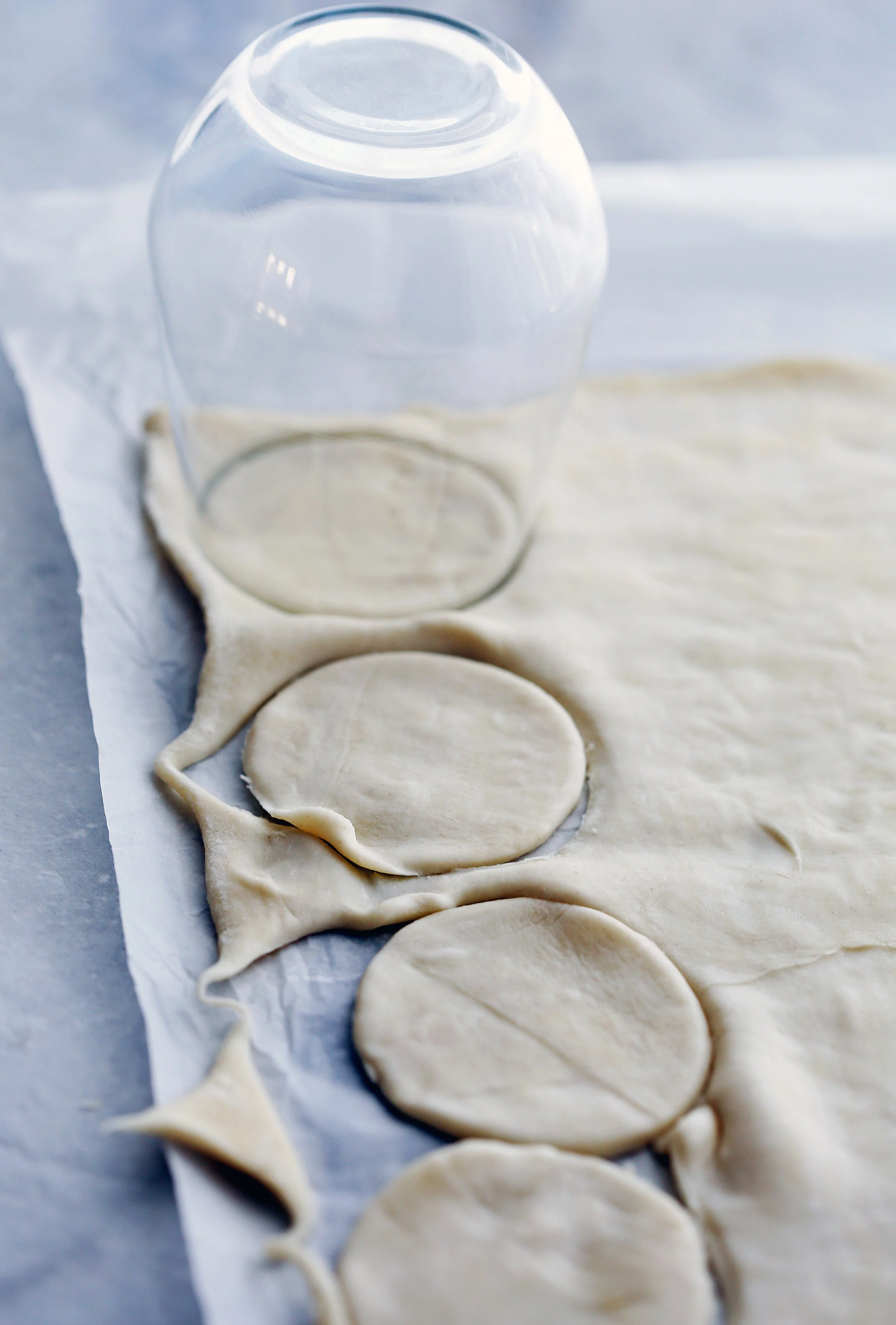 Puff pastry with circles cut out of it using the rim of a drinking glass.