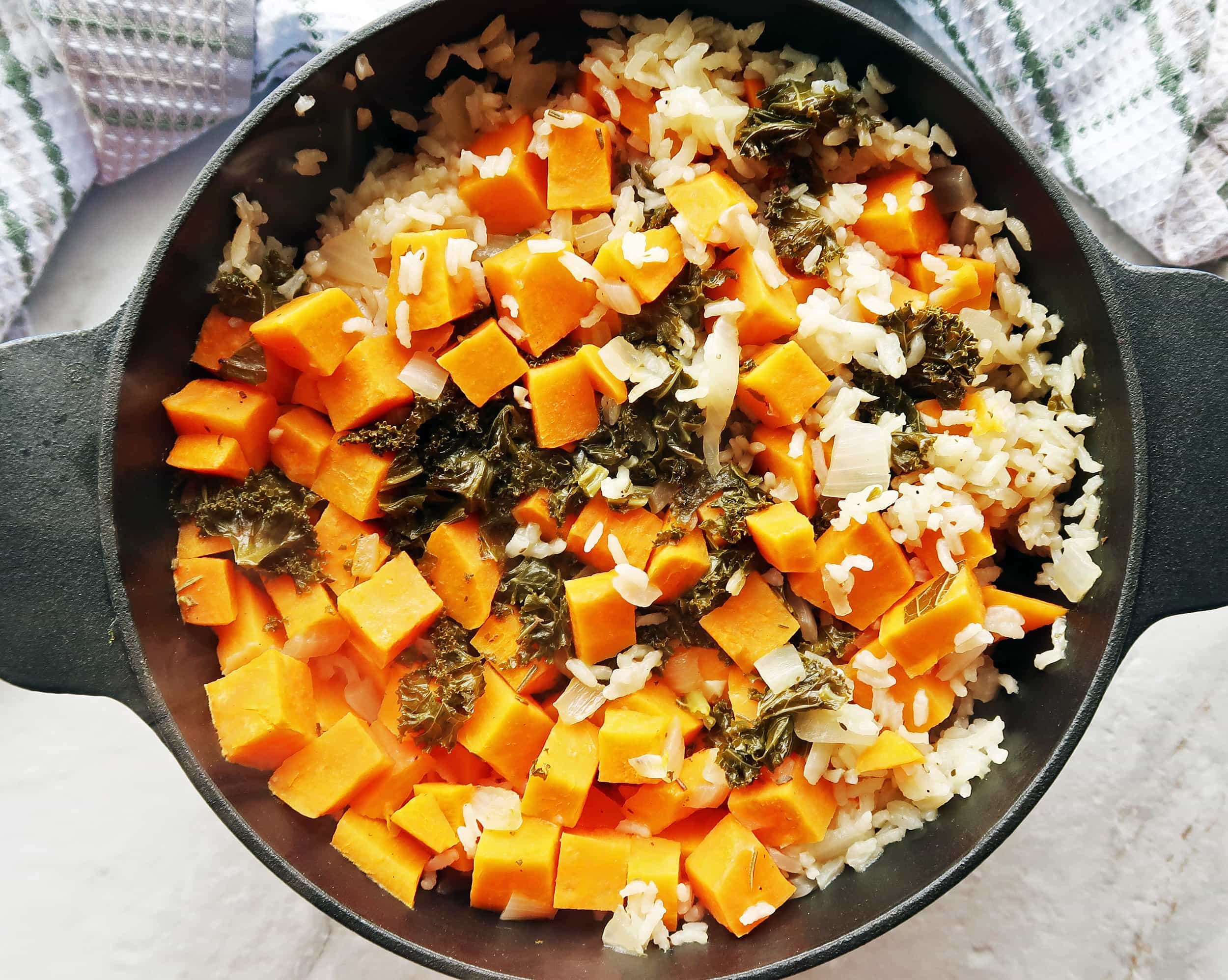 A Dutch oven full of vegetarian, gluten-free sweet potato and kale baked risotto.