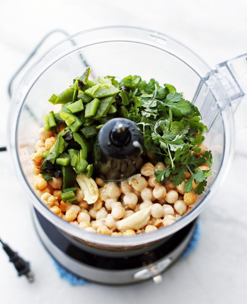 Roasted jalapeno, cilantro, chickpeas, garlic, lemon, olive oil, and spices in a food processor.