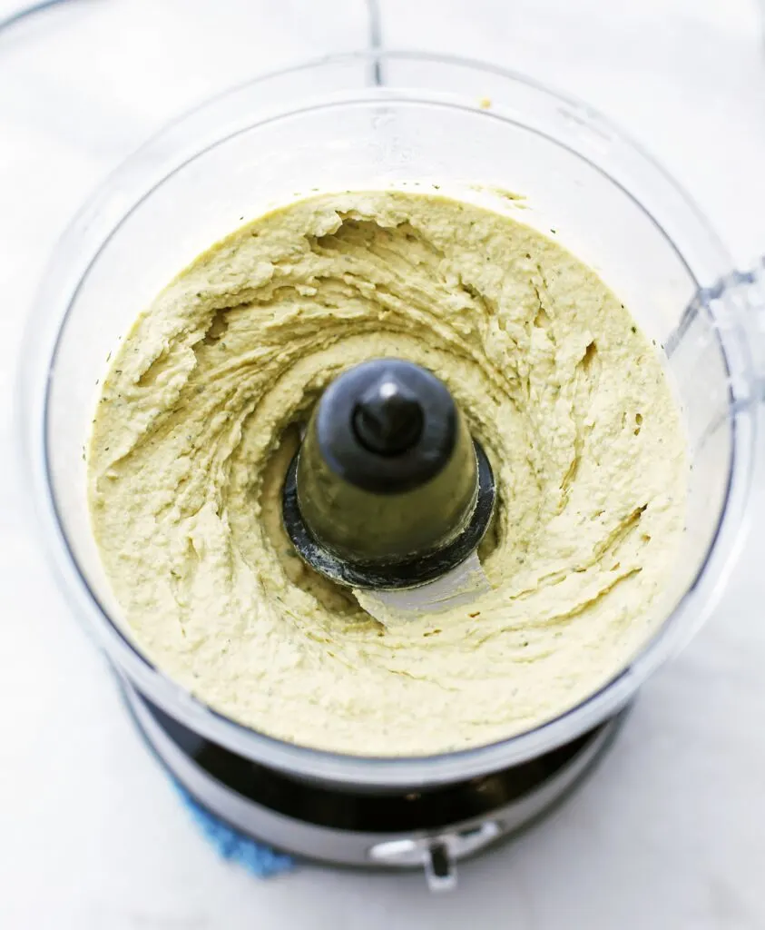 Blended creamy roasted jalapeno cilantro hummus in the food processor.