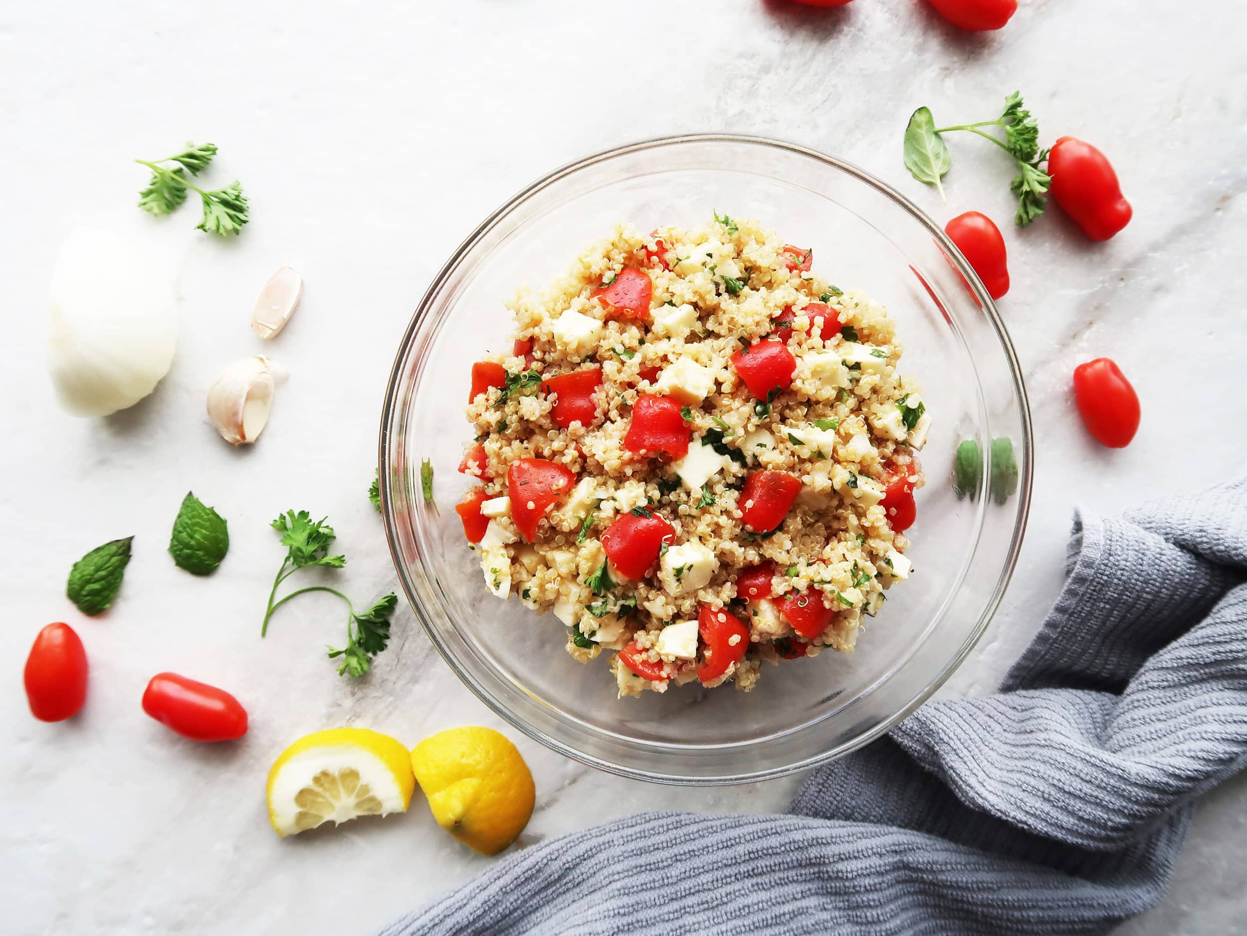 Fresh Tomato, Mozzarella, and Herb Quinoa Salad surrounded by ingredients.