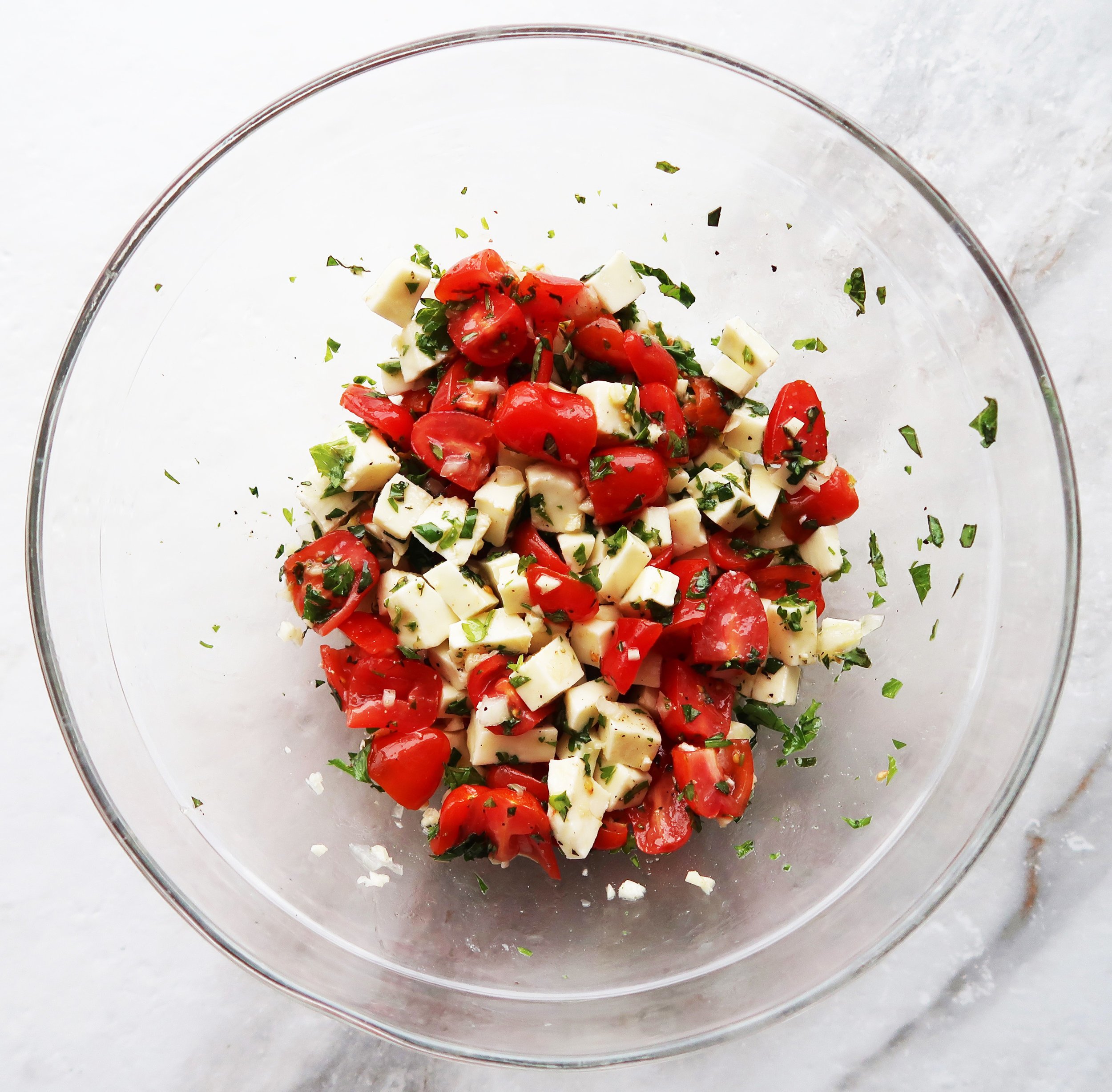 Tomatoes, mozzarella, and herbs tossed together.