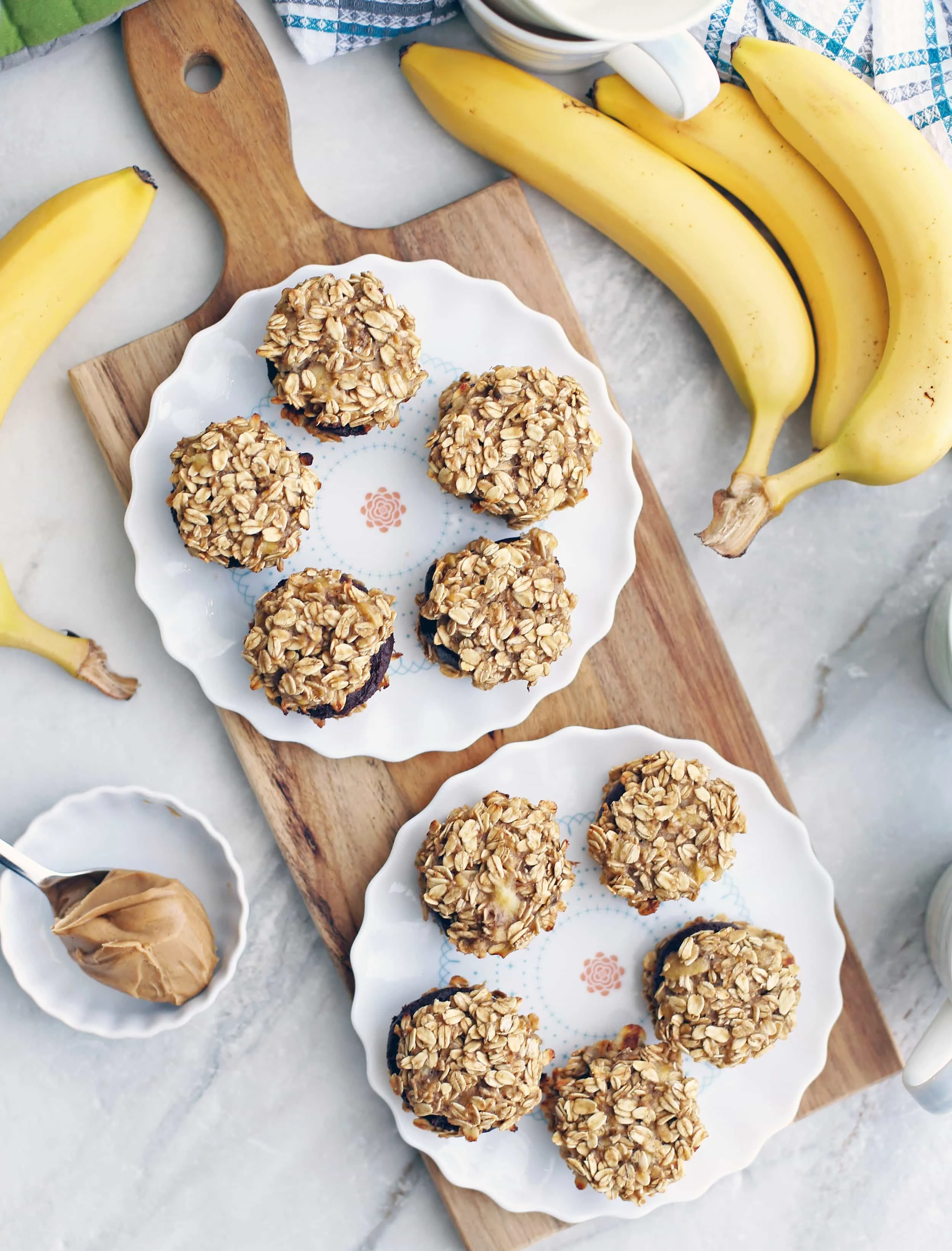 Overhead view of two plates, each holding five banana oatmeal sandwich cookies with peanut butter cocoa filling.