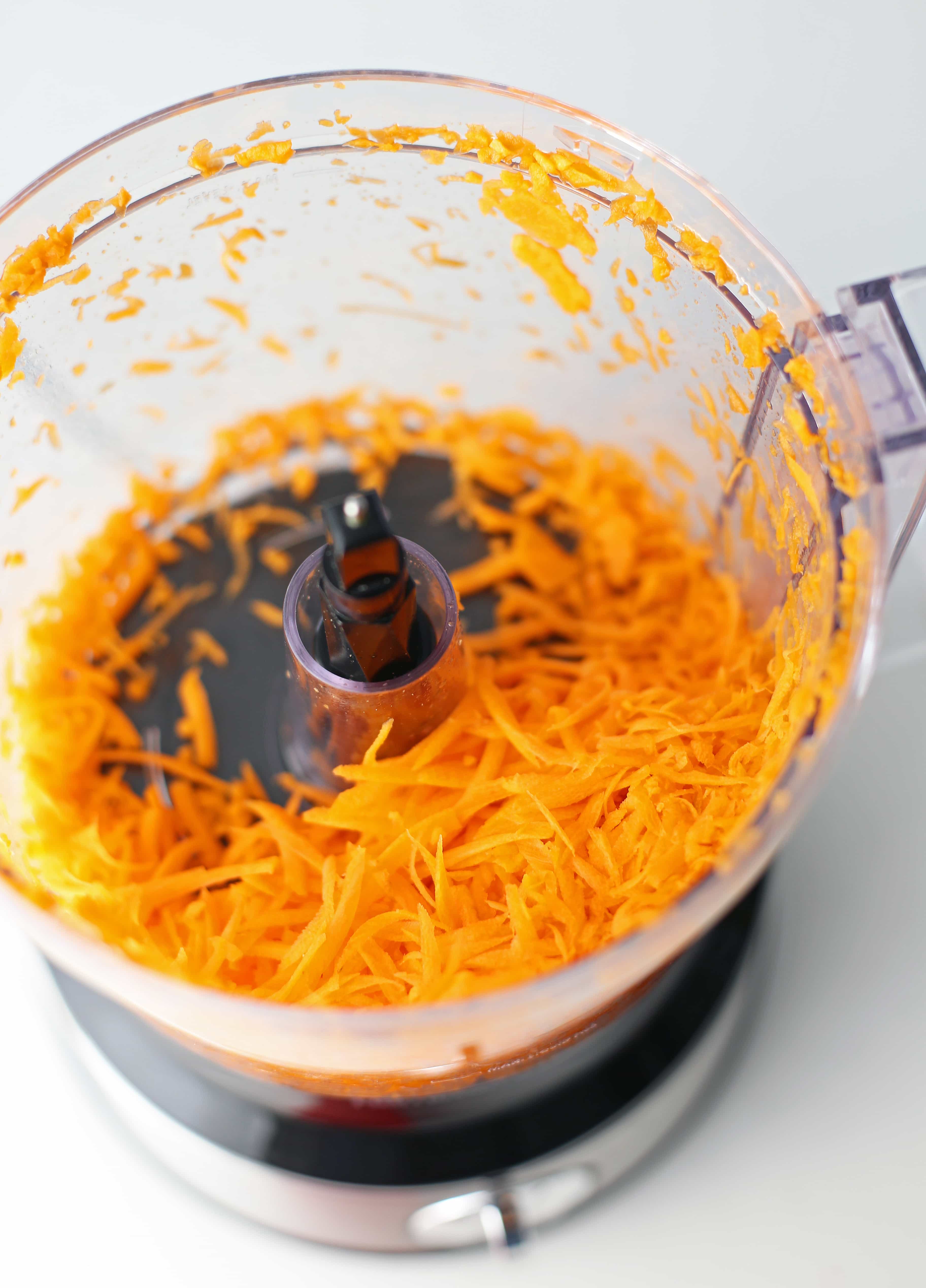 Shredded carrots in a food processor.