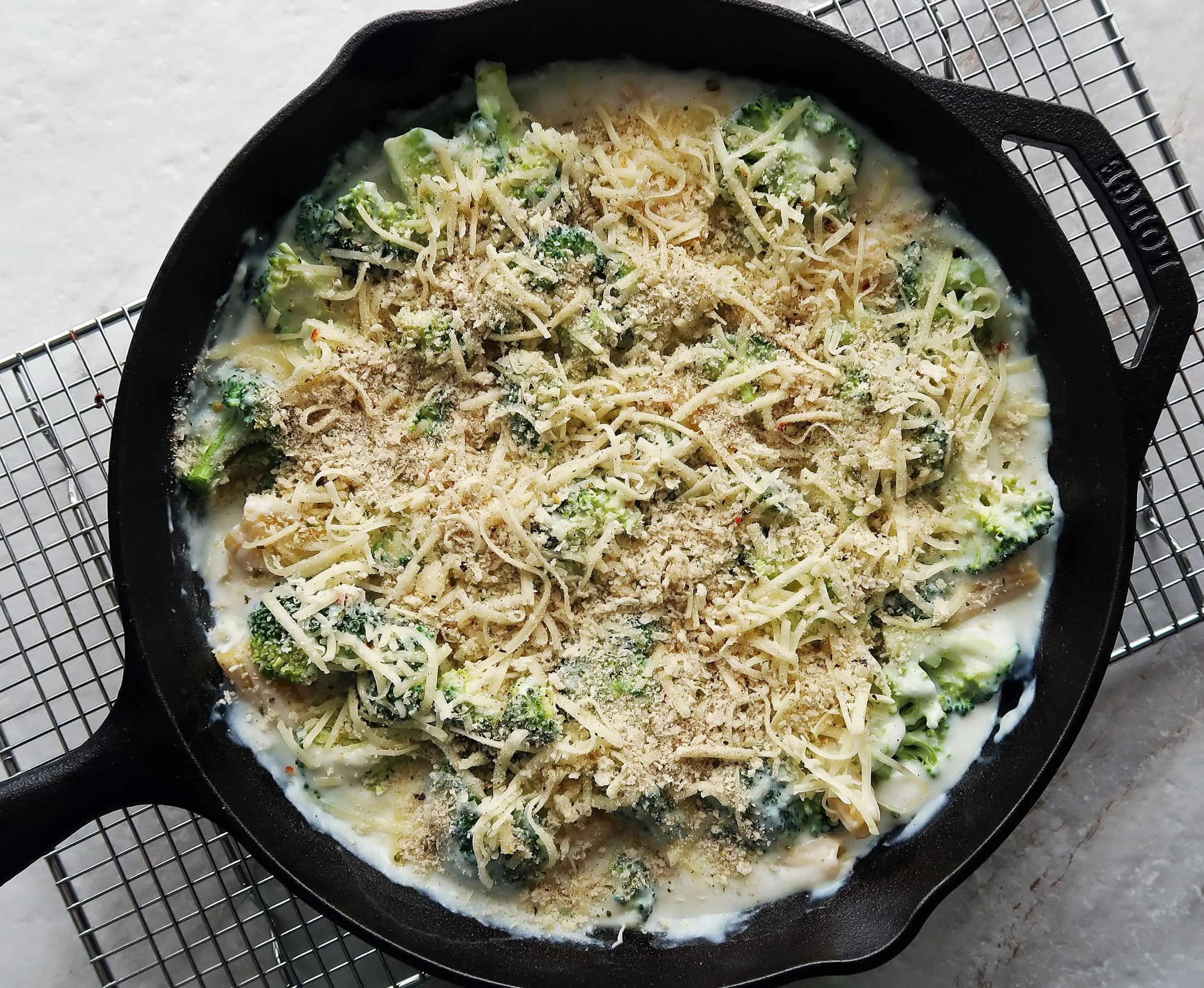 A skillet pasta bake topped with cheese and breadcrumbs.