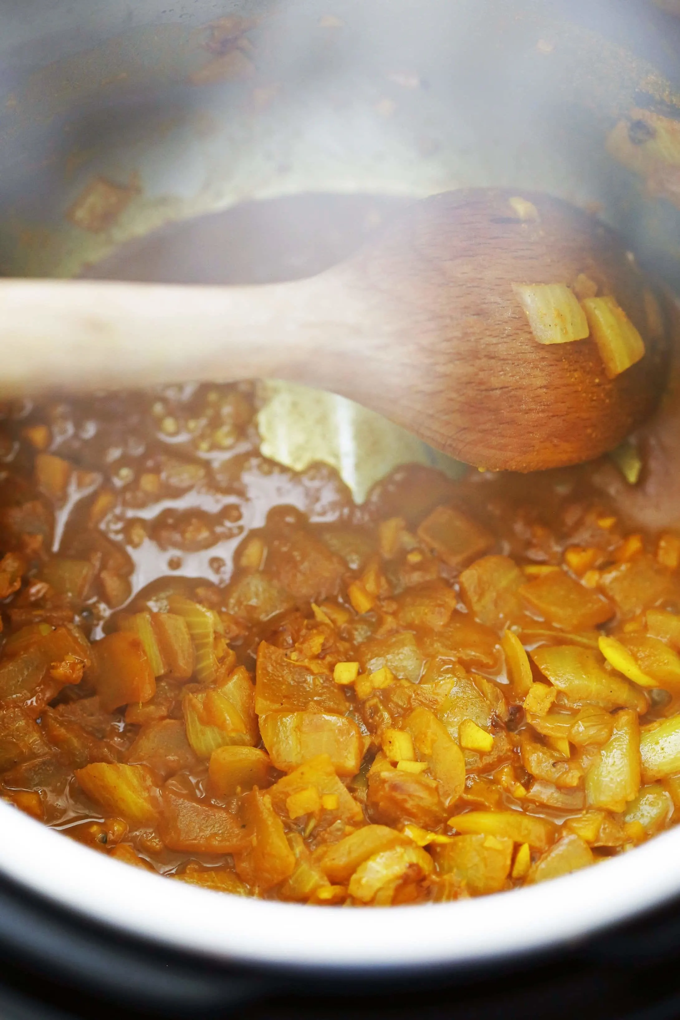 Sautéed onions, garlic and ginger mixed with spices in the Instant Pot.