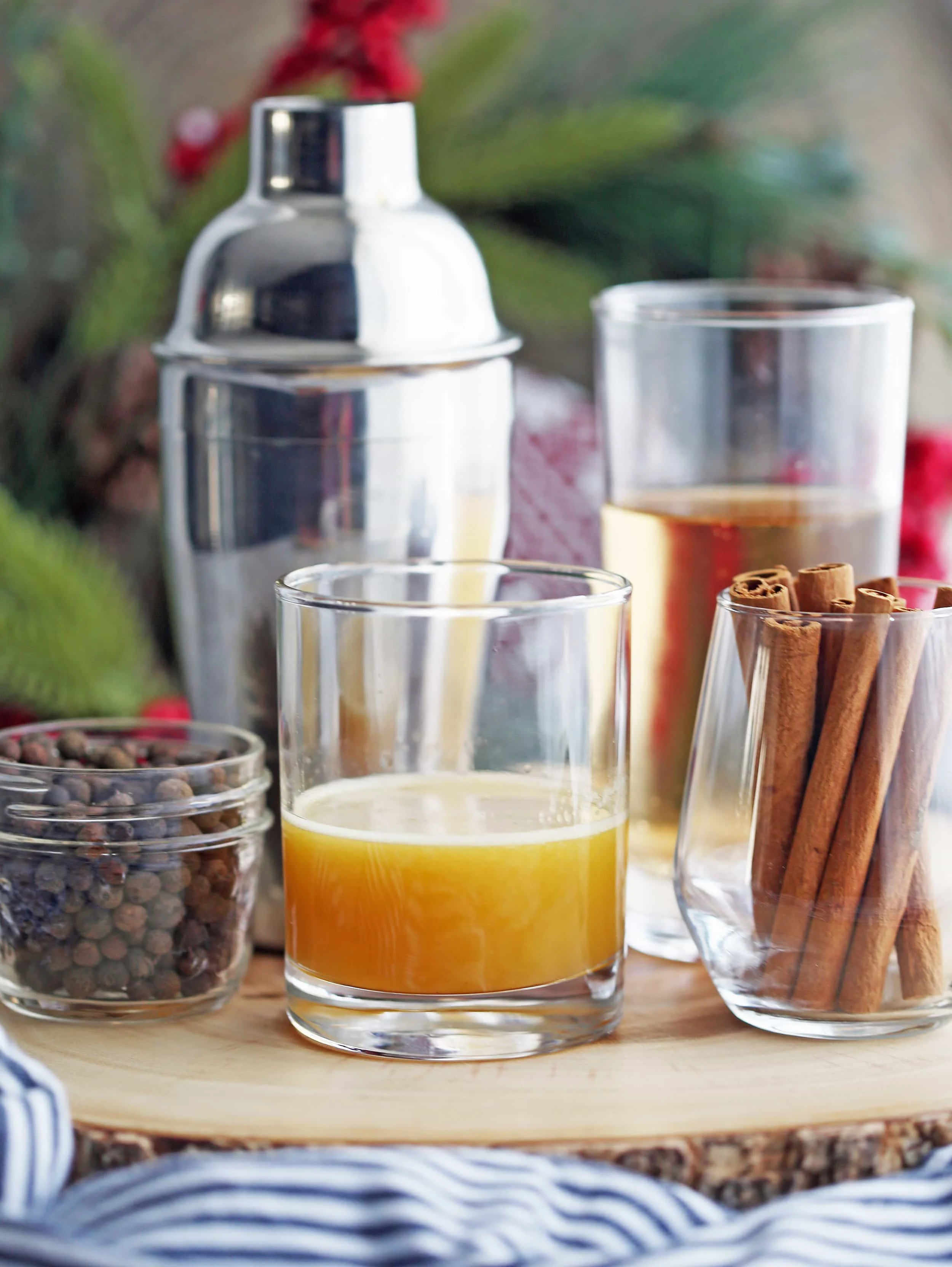 A mixture of brandy, orange juice, and spices in a double-old fashioned glass.