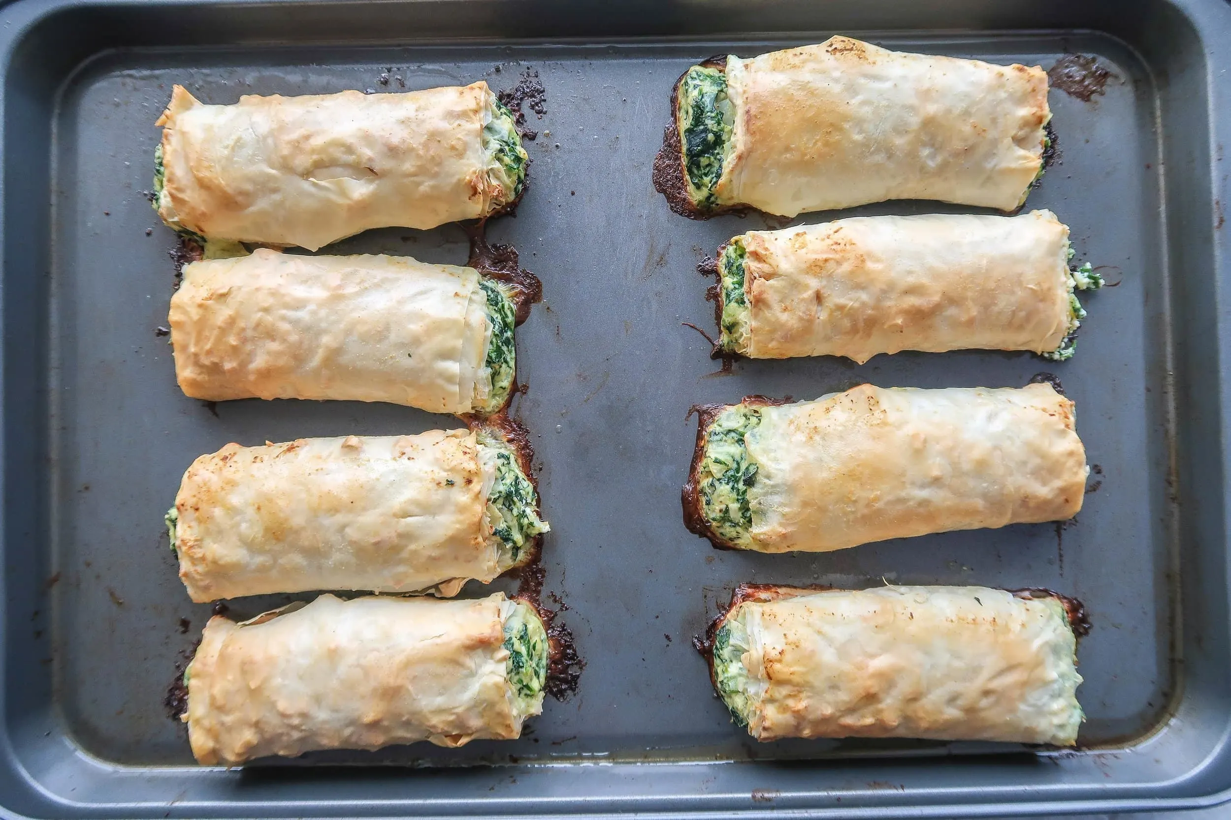 Baked spanakopita rolls.